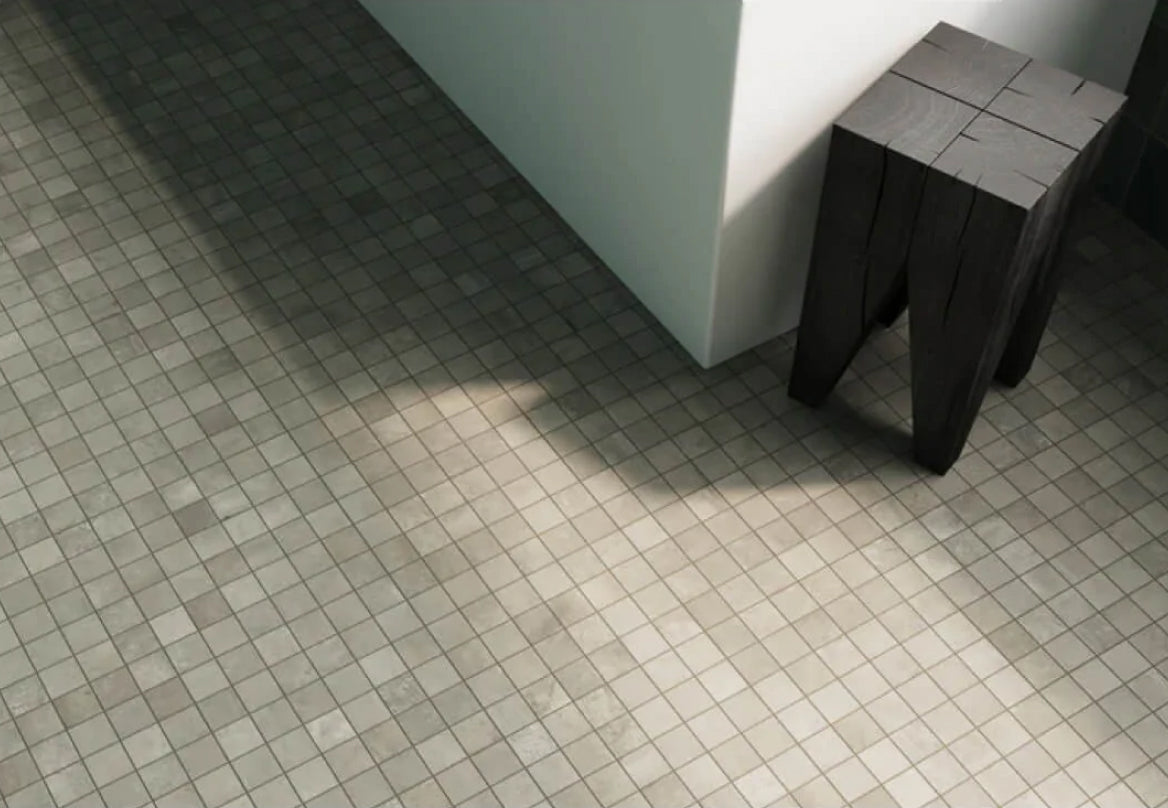 Chic bathroom floor graced with small square mosaic tiles in varying shades of gray, capturing understated elegance