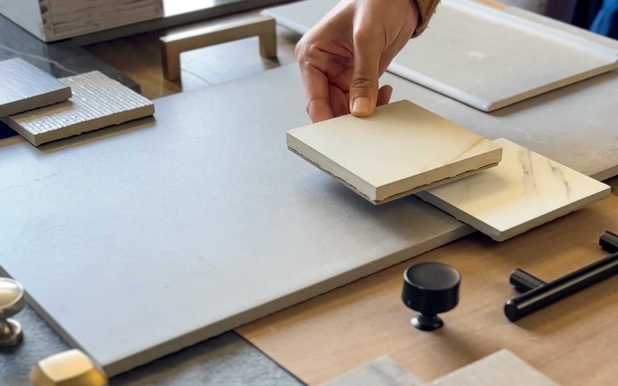 A professional designer meticulously selects tile samples for an upcoming project, illustrating the personalized options available through our Exclusive Trade Program. Elevate your designs with our specialized support, exclusive discounts, and first access to premium tiles.