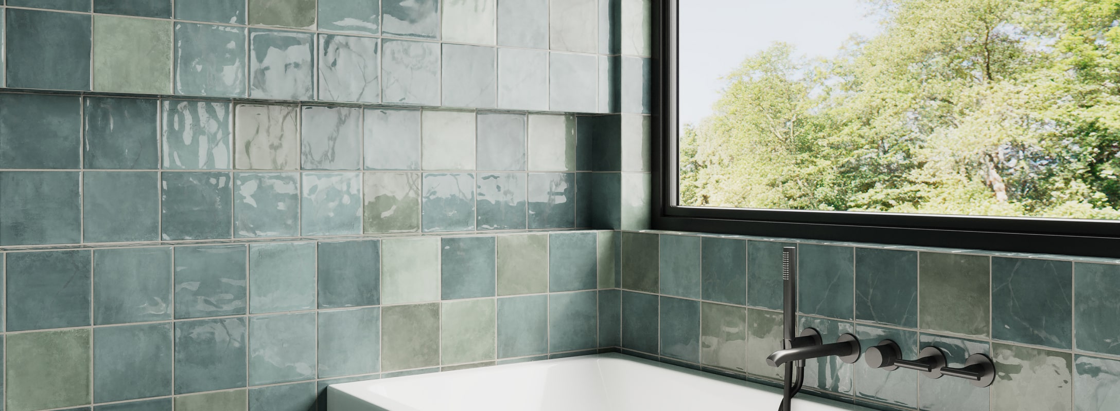 Glossy teal square wall tiles frame a serene bathtub area, enhanced by a black matte faucet and a view of lush greenery.