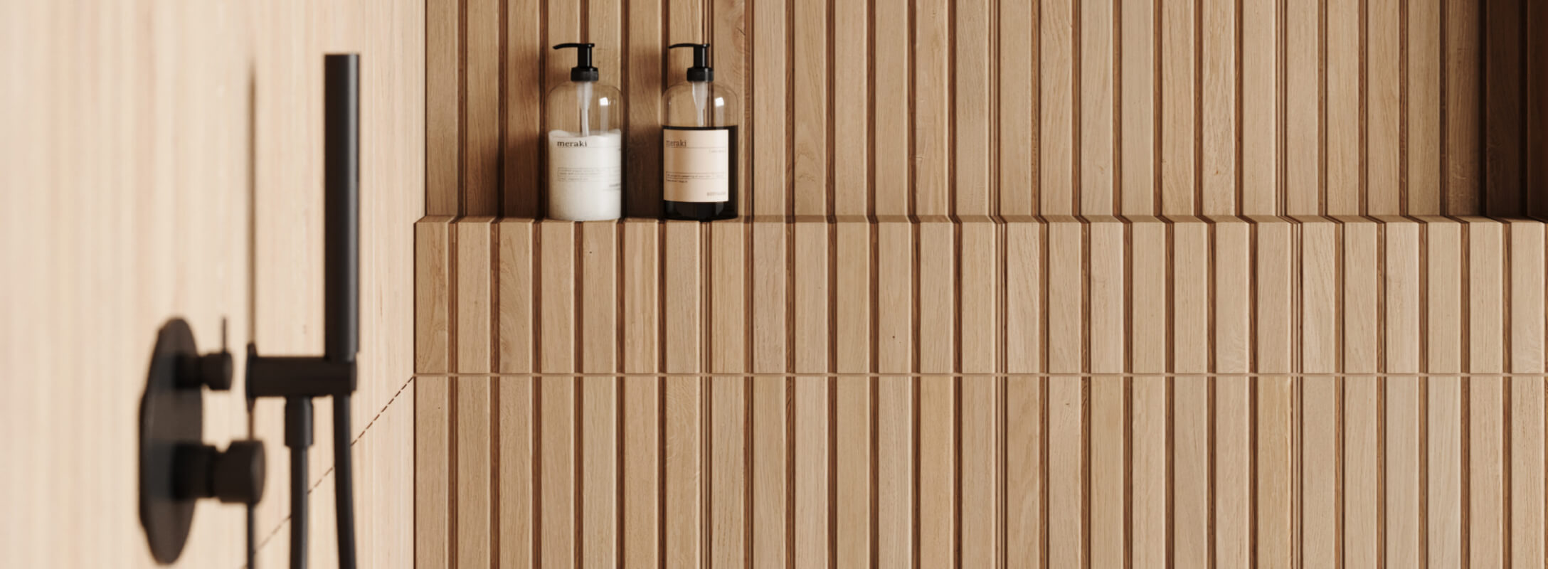 Minimalist bathroom wall featuring vertical light wood tiles and elegant black fixtures, for a clean, modern look