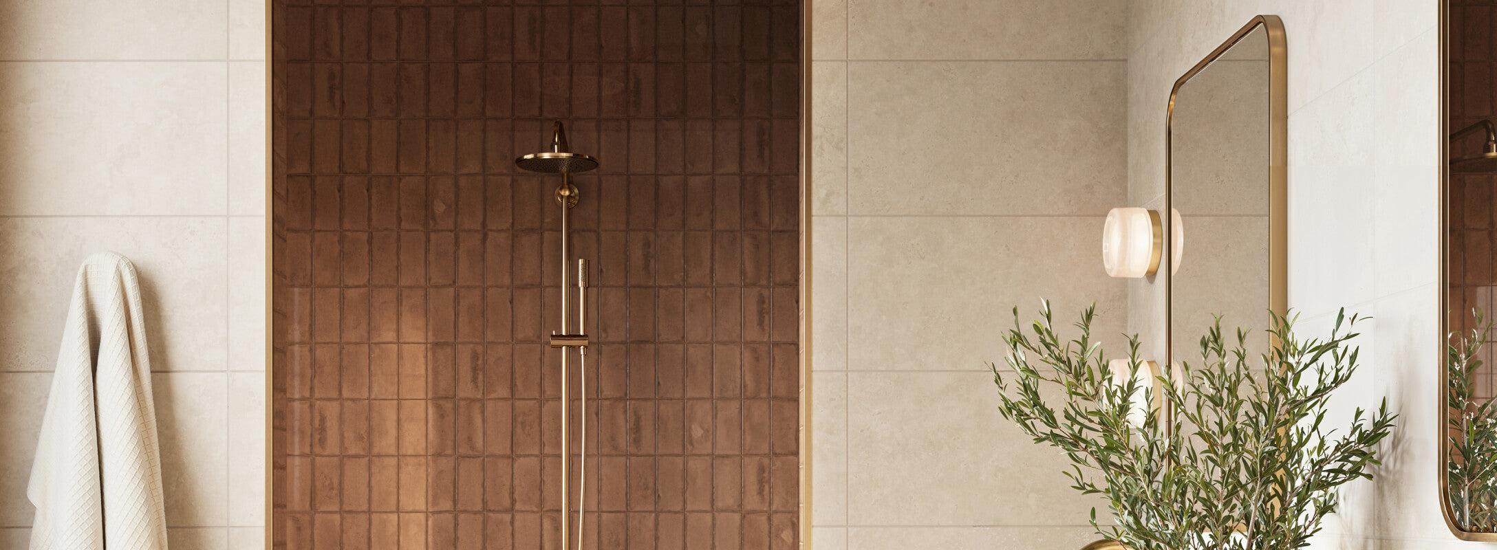 Elegant bathroom featuring rich brown shower tiles with a textured finish, complemented by soft beige wall tiles and gold accents