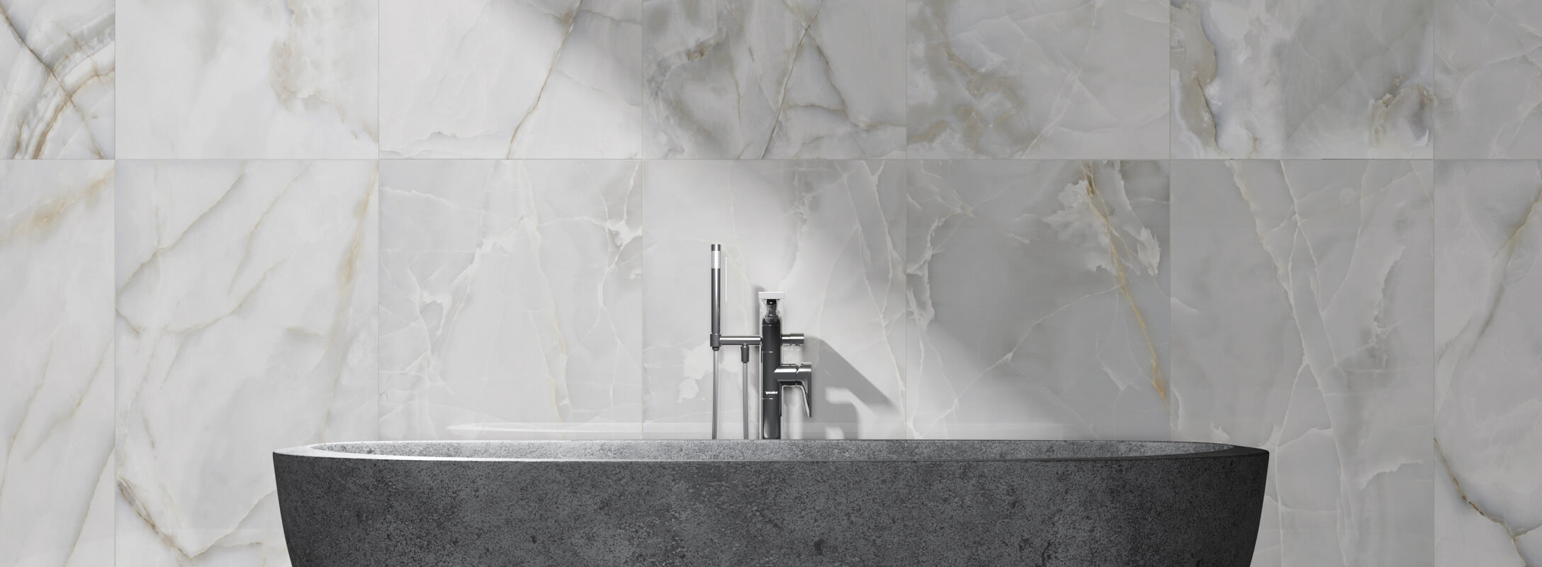 Striking marble wall tiles in elegant white with dramatic grey veining, framing a contemporary stone basin for a luxurious bathroom design