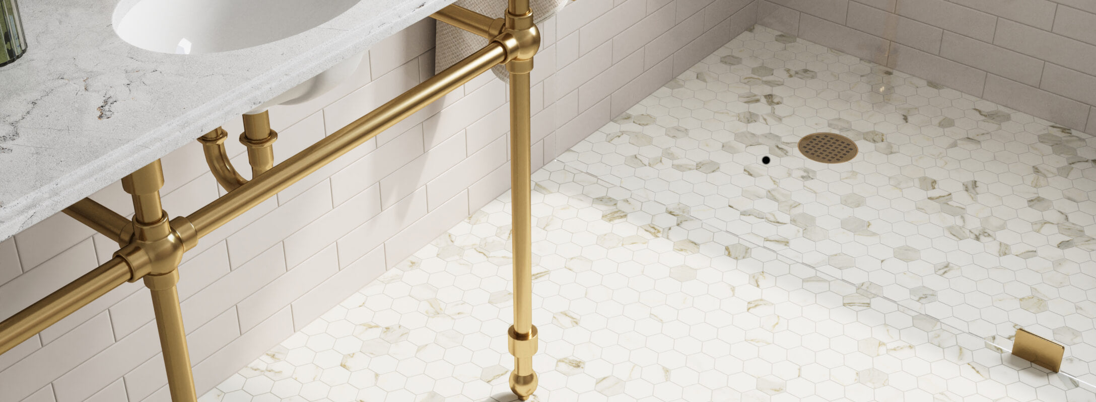 Modern bathroom featuring a white marble hexagon tile floor with gold fixtures and a white subway tile wall