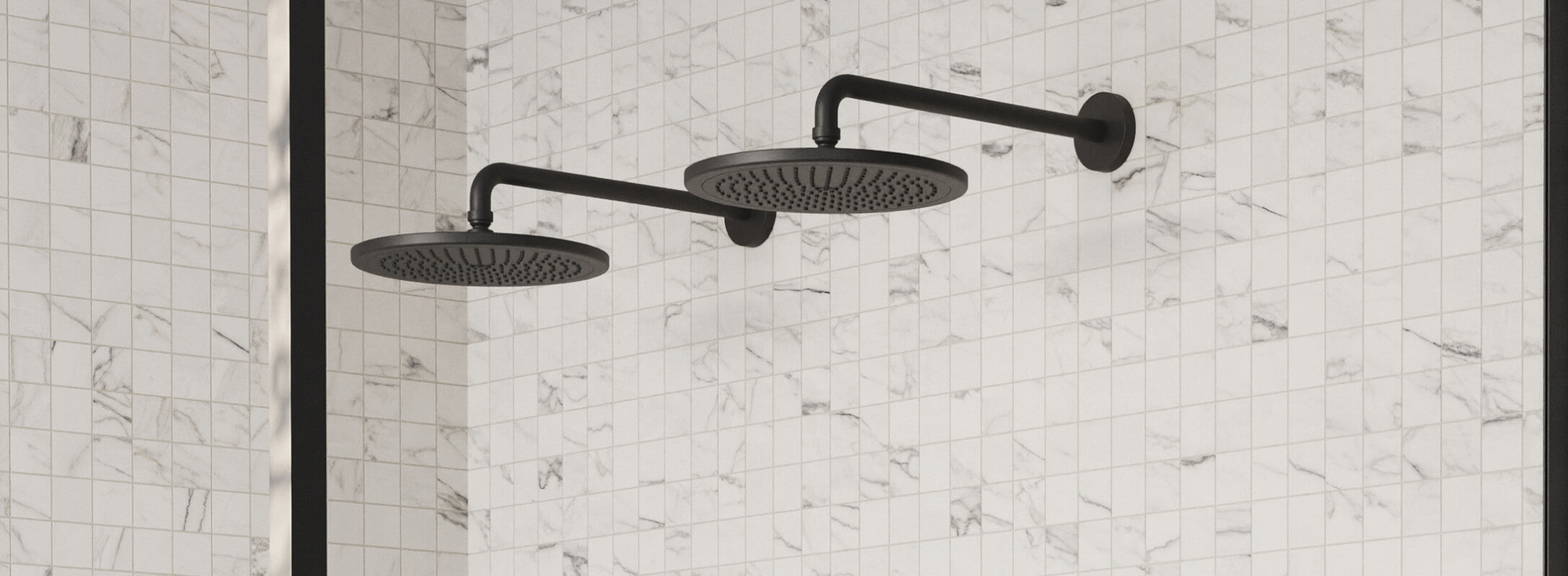 Modern bathroom with dual black shower heads against a backdrop of white marble mosaic tiles