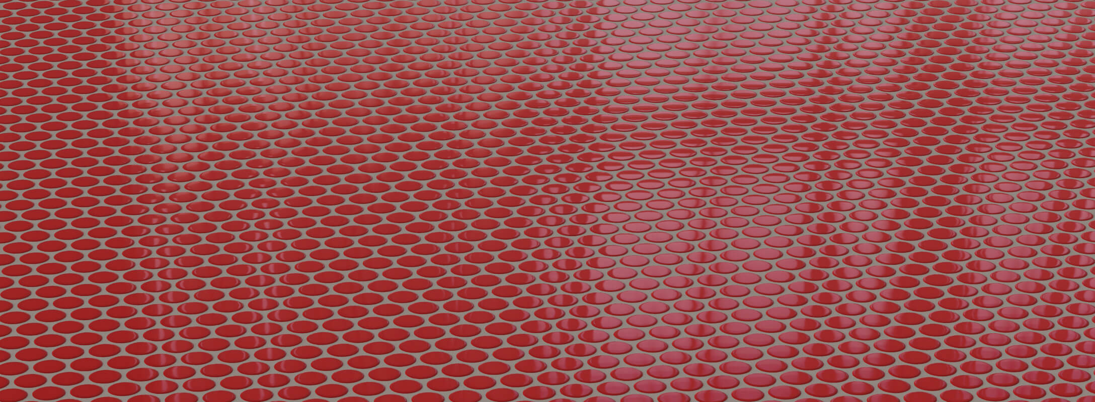 Bright red penny round tiles creating a vibrant and modern floor design, perfect for bold interior spaces