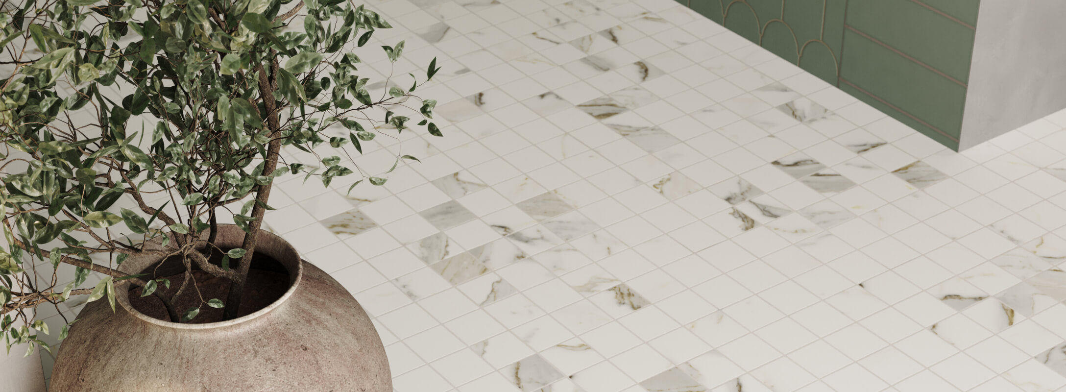 Top-down view of a floor tiled with elegant white marble look square mosaics featuring subtle gray veining, accented by a large terracotta pot holding lush greenery.