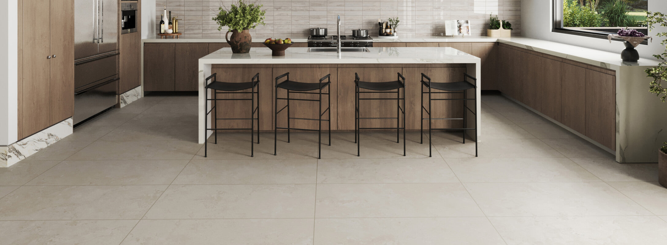 Spacious kitchen featuring large beige floor tiles, a white marble-topped island with black bar stools, and wooden cabinetry for a modern, inviting look