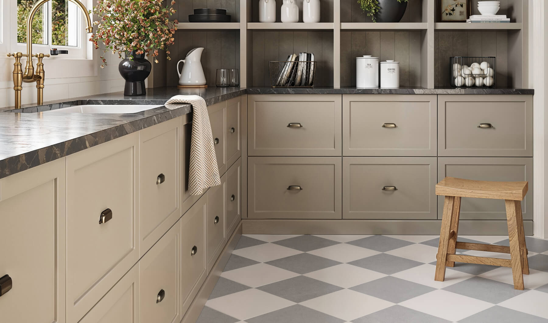 Charming kitchen with beige cabinets, black marble countertops, and grey-and-white checkered floor tiles, complemented by open shelving and brass fixtures