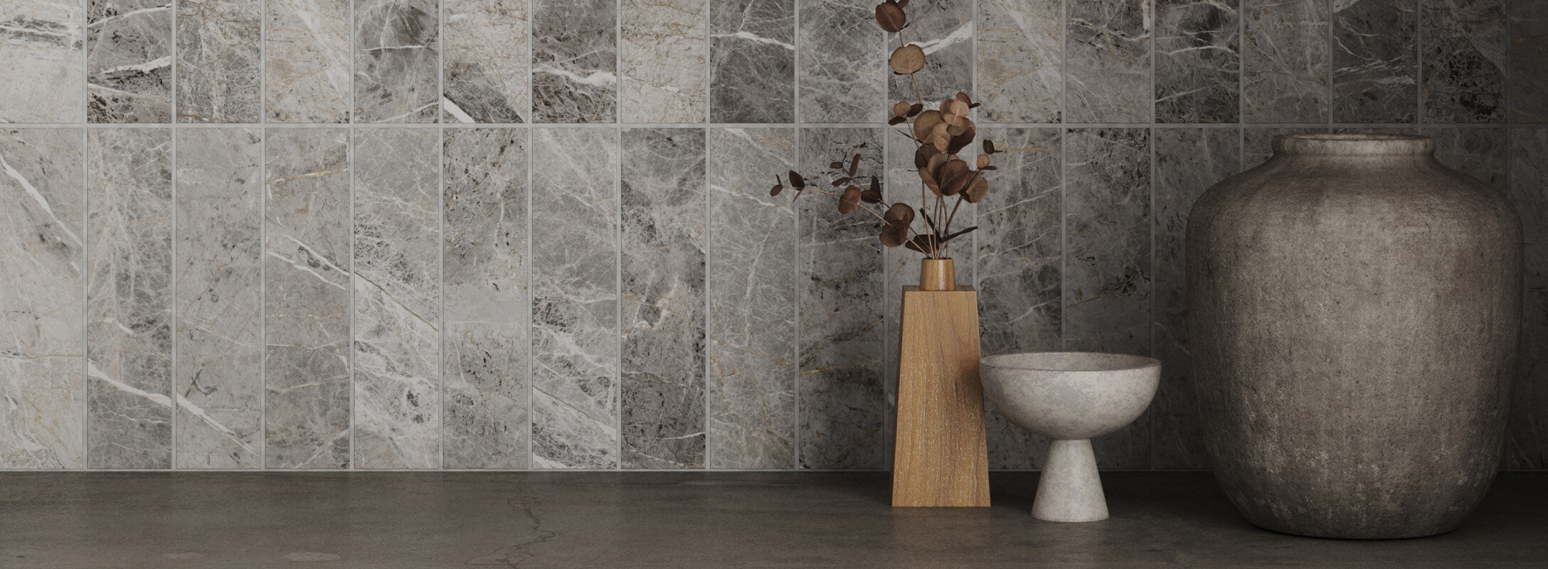 Sophisticated kitchen setup featuring elegant grey marble look tiles, complemented by a minimalist decor with earthy vases and dried floral arrangements