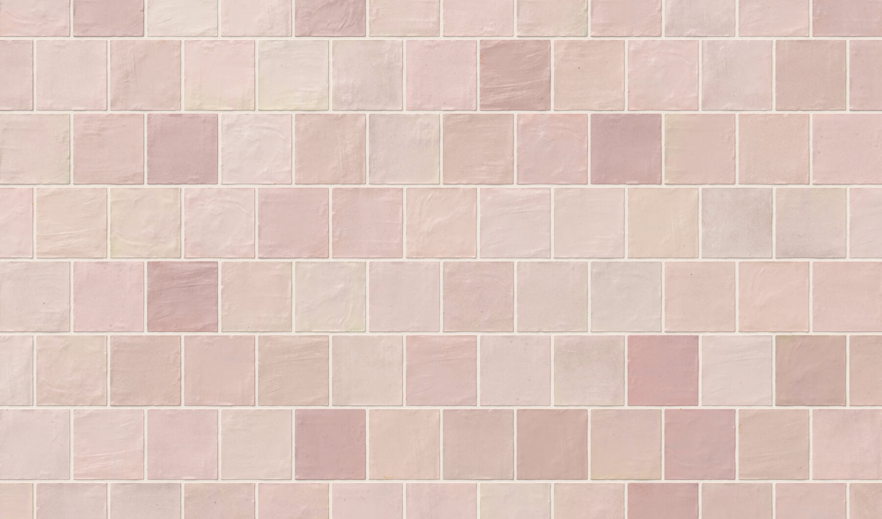 Soft red square tiles in light shades with a subtle, textured finish, adding a delicate and charming aesthetic to kitchen walls