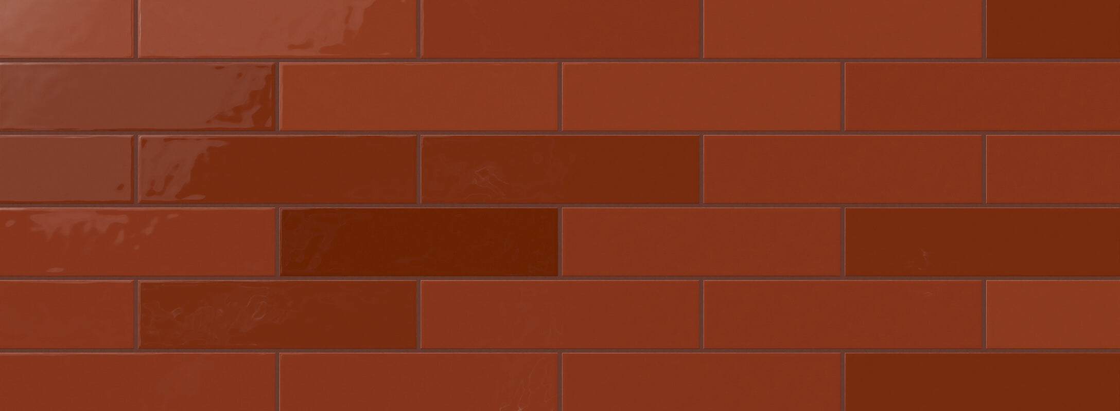 Rich red subway tiles with a glossy finish, offering a warm and vibrant touch to kitchen walls