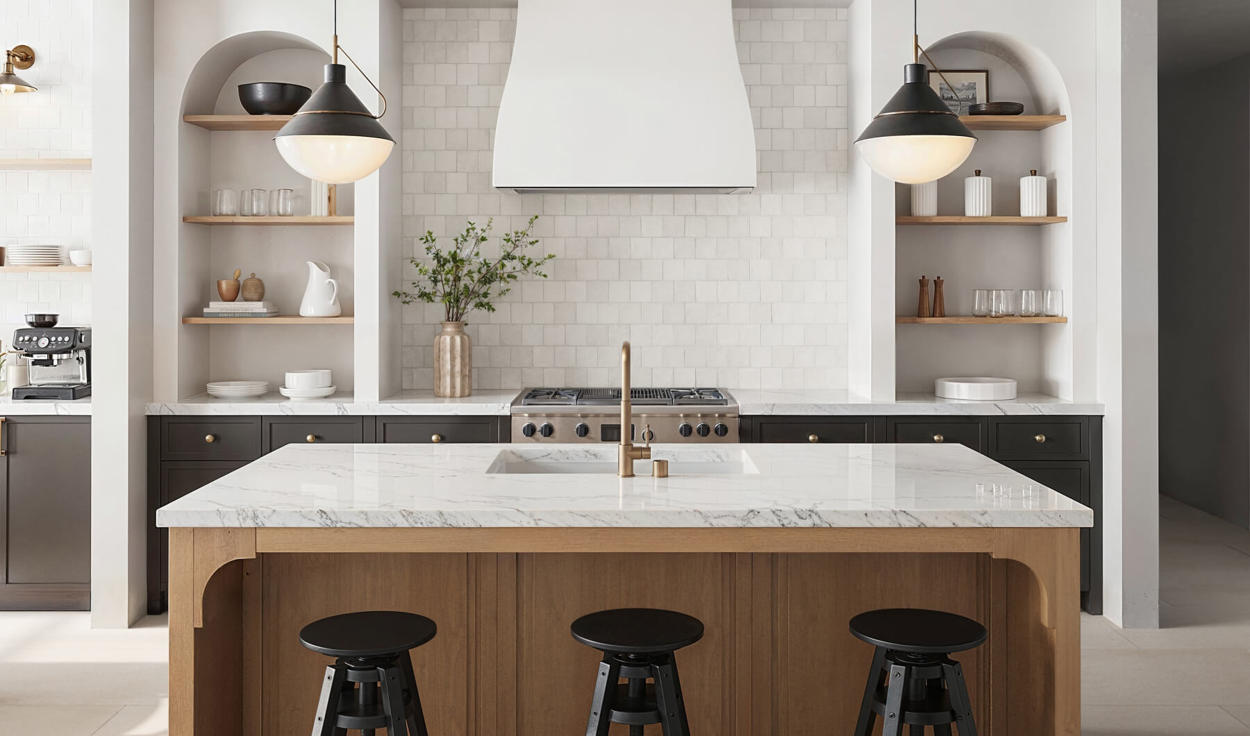 Modern kitchen with white square tiles on the wall, open shelves, a marble island, and black and gold accents
