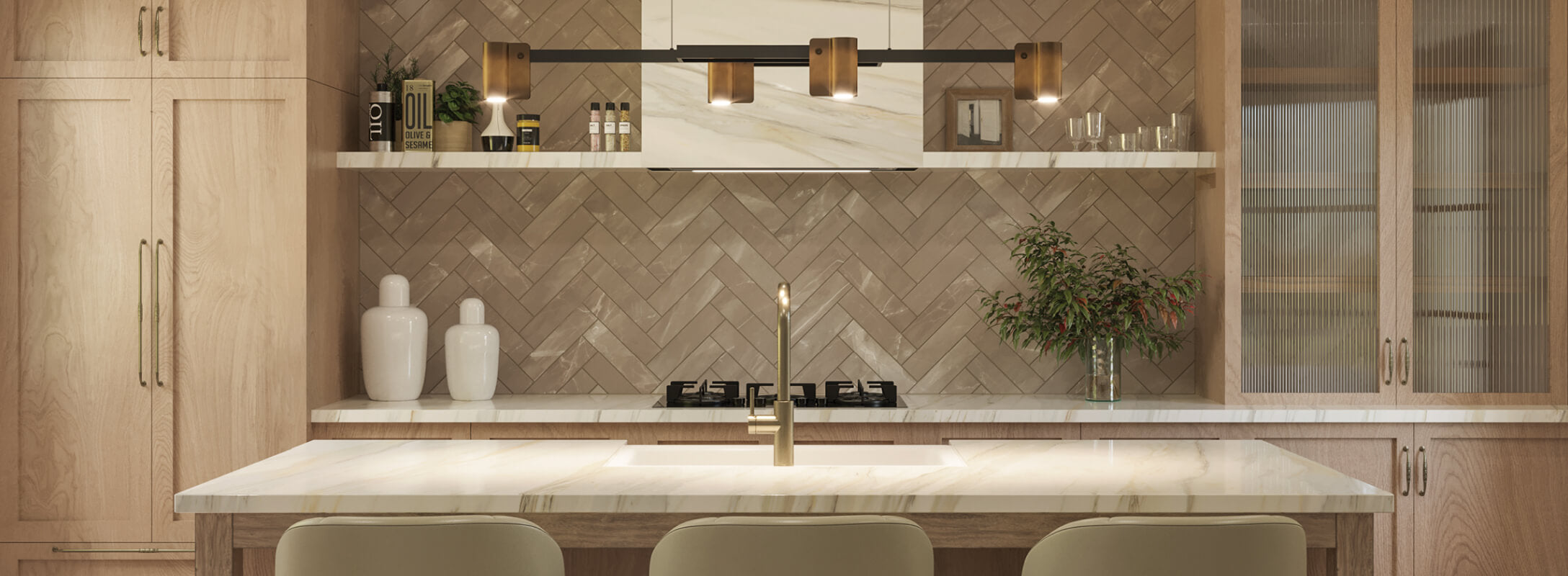 Modern kitchen with light wood cabinets and herringbone-patterned 3x12 beige tiles, accented with marble countertops and bronze fixtures