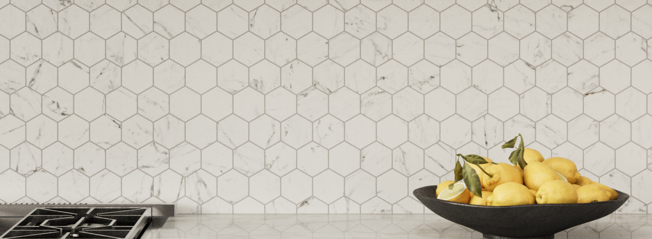 White hexagonal mosaic tiles with subtle marble veining create a sophisticated and clean kitchen backsplash.