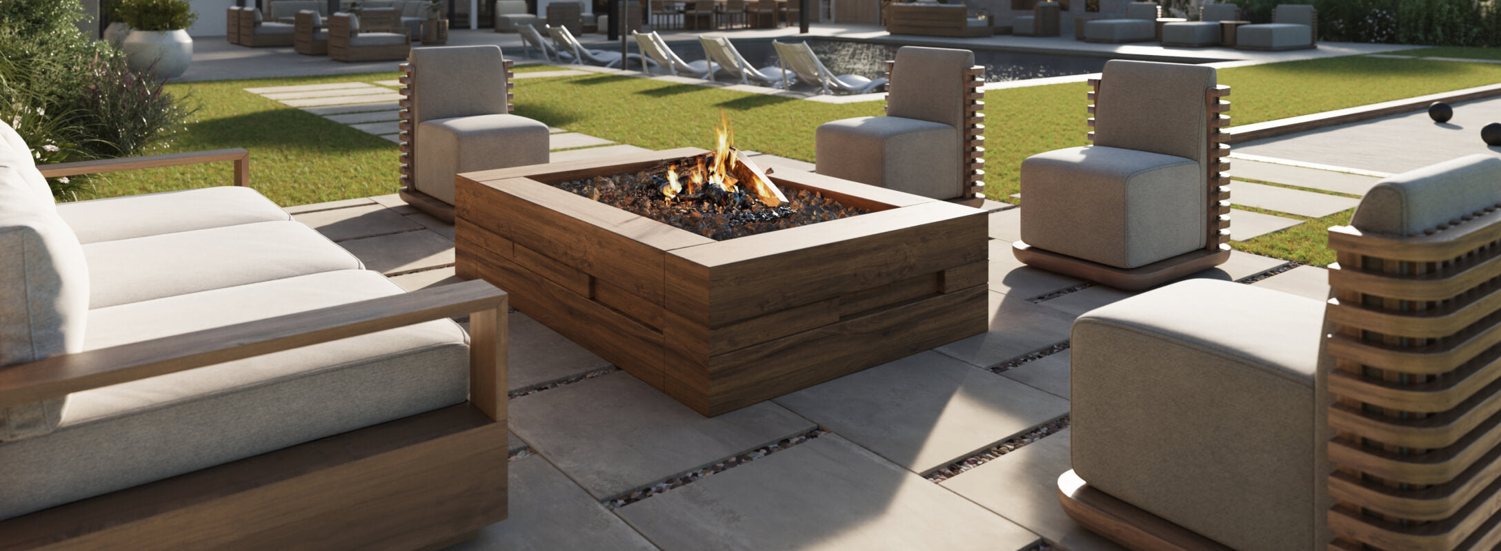 Elegant outdoor seating area with a modern fire pit, featuring sleek paver tiles and lush green surroundings.