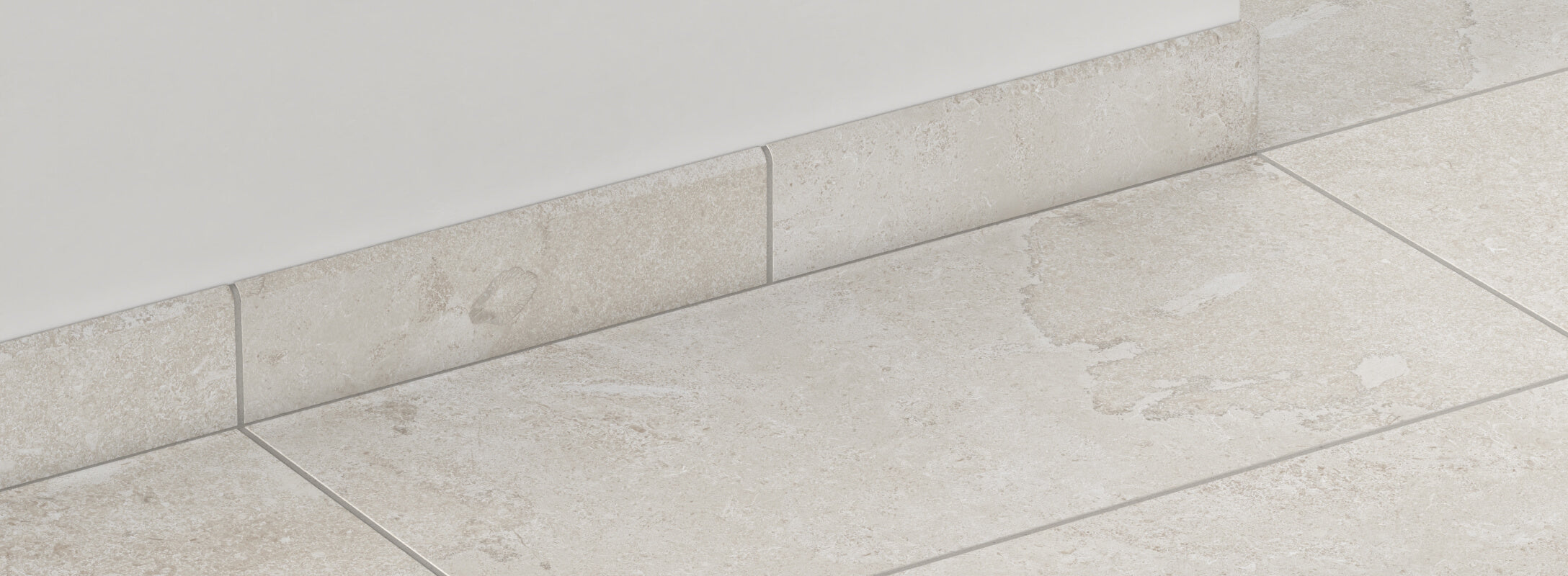 Beige stone-look tiles with natural textures are perfectly complemented by matching edge trims, creating a seamless and elegant finish.