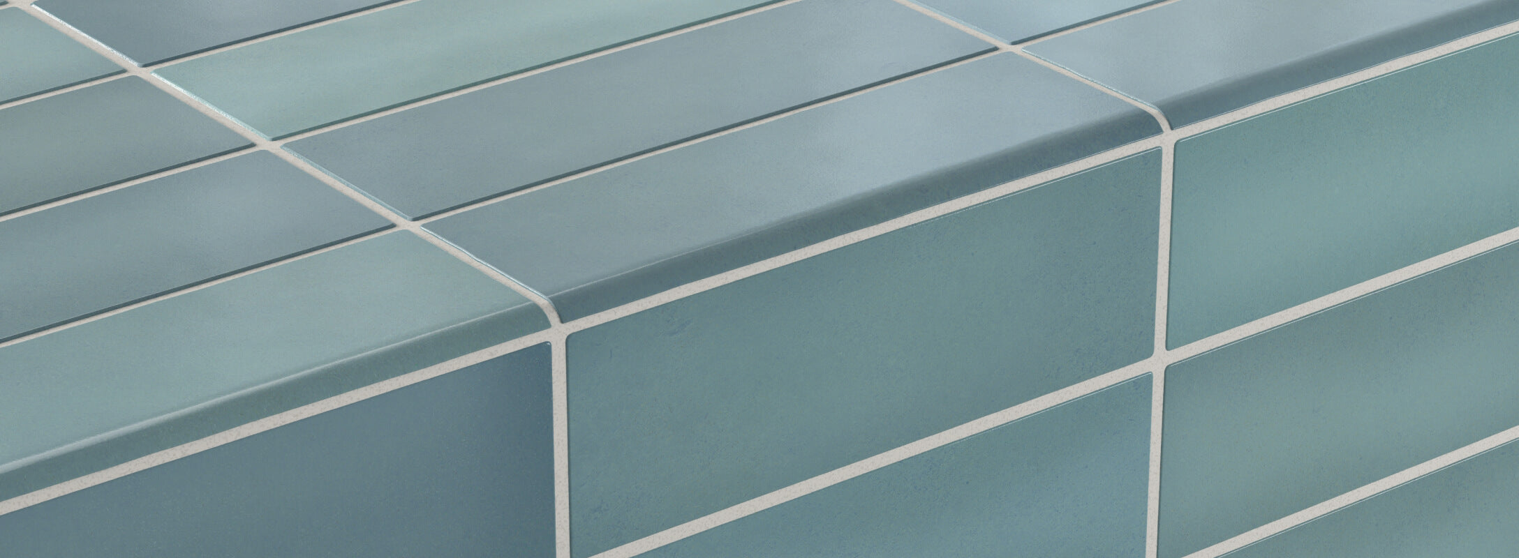 Soft aqua blue tiles with rounded edge trim, accented by clean white grout lines for a fresh and vibrant look.