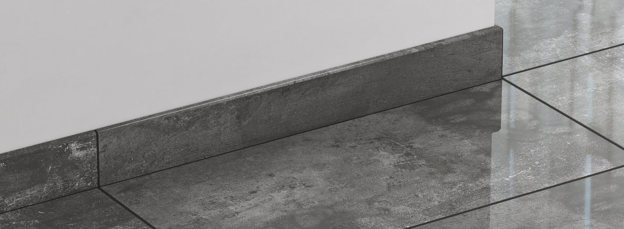 Matte dark grey stone look tiles with matching edge trim, creating a sleek and modern finish with a bold, industrial vibe.