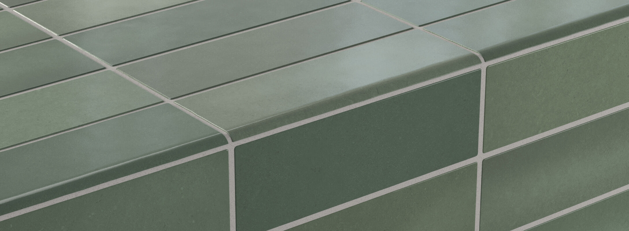 Green tile edge trim with a matte finish, showcasing sleek corners and smooth edges for a polished and modern design accent.