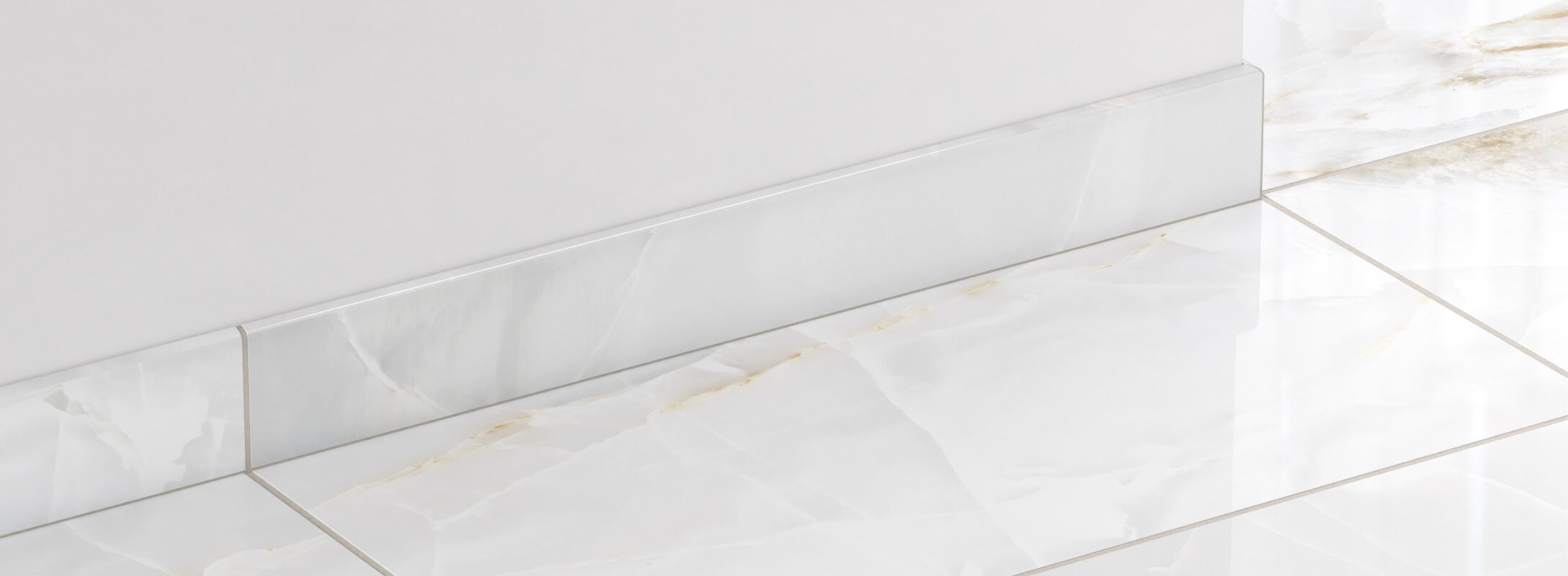 Glossy light grey marble look tiles with soft veining and matching edge trim, exuding a refined and luminous finish.
