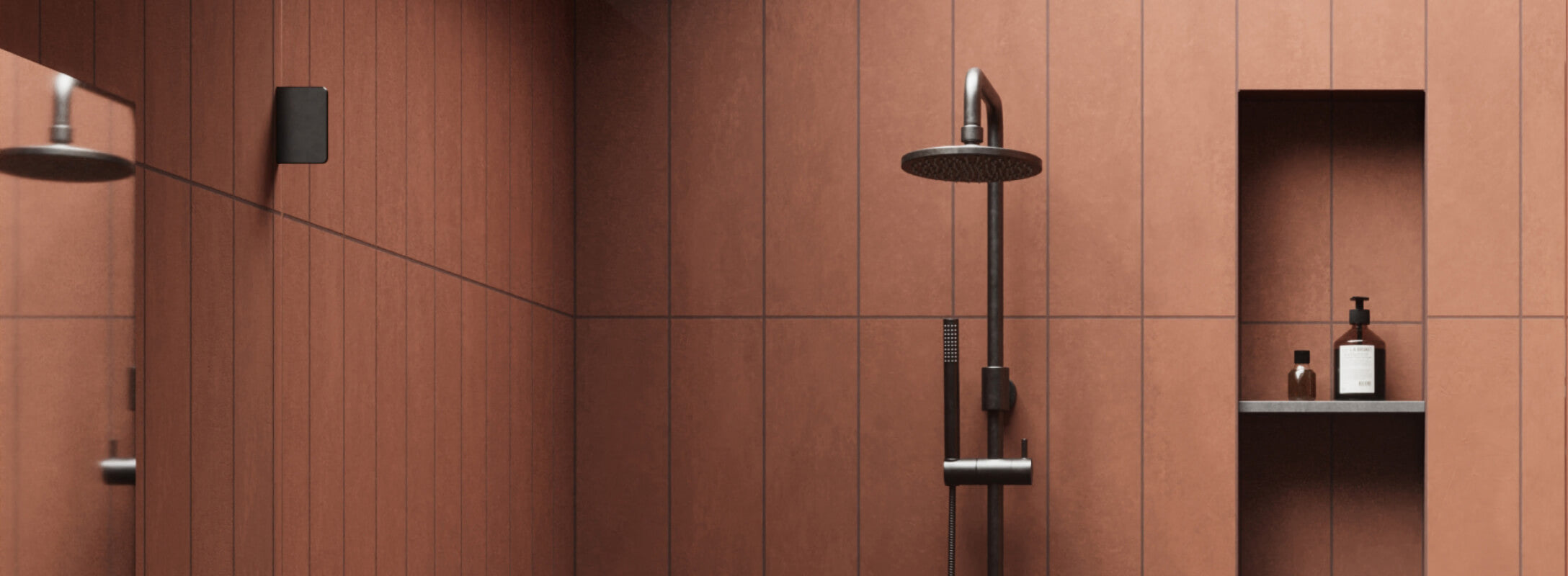 Contemporary shower with sleek red wall tiles and matte black fixtures, featuring a built-in shelf with minimalist bath essentials for a refined look