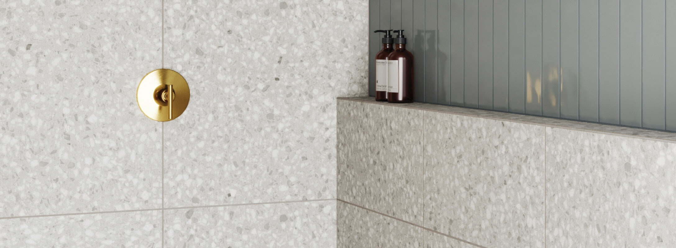 Chic terrazzo tiles with a sleek golden faucet and earth-toned accessories create a modern bathroom vignette
