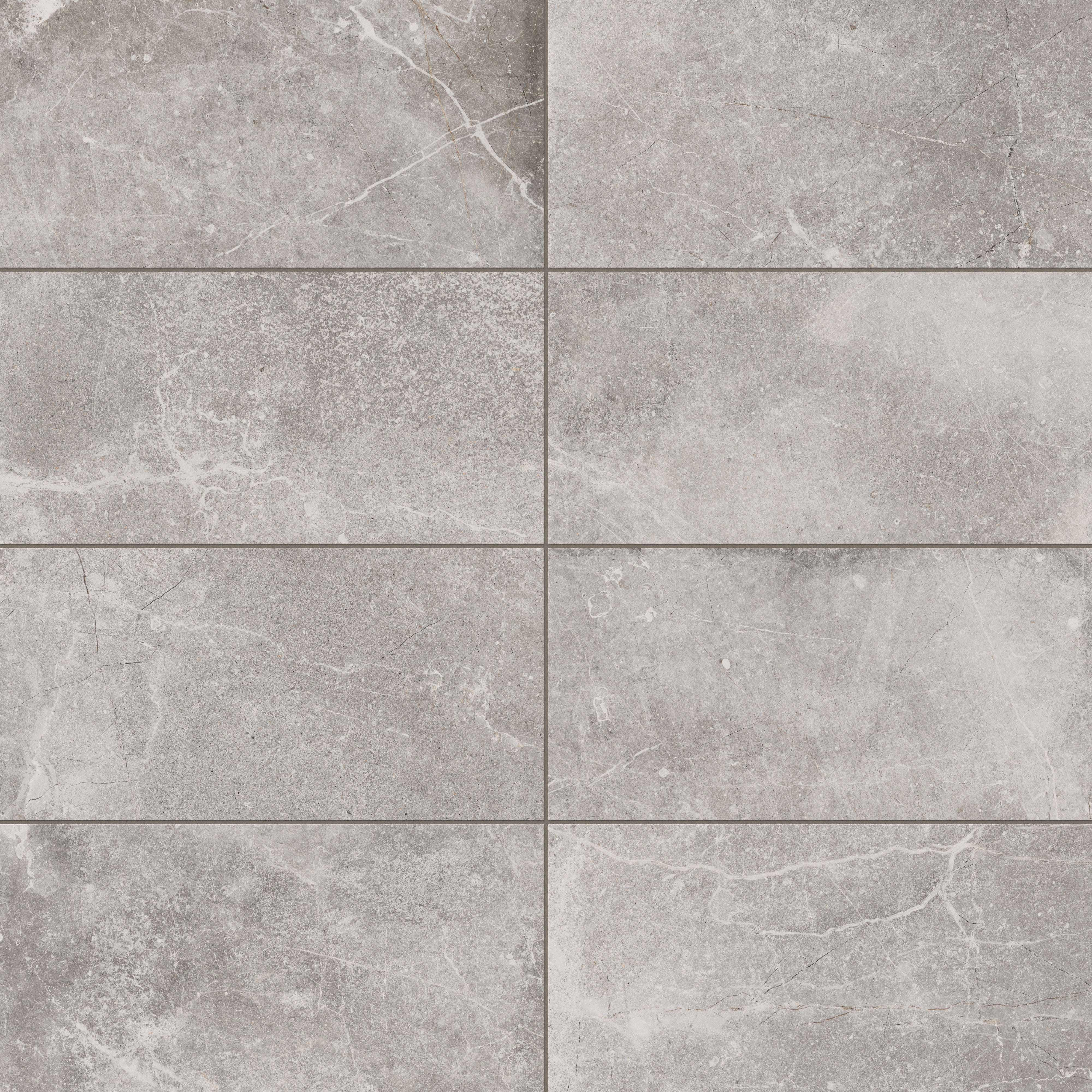 Matte porcelain tile in a 12x24 size, showcasing a muted gray hue with natural stone-inspired veining, perfect for modern and sophisticated interiors.