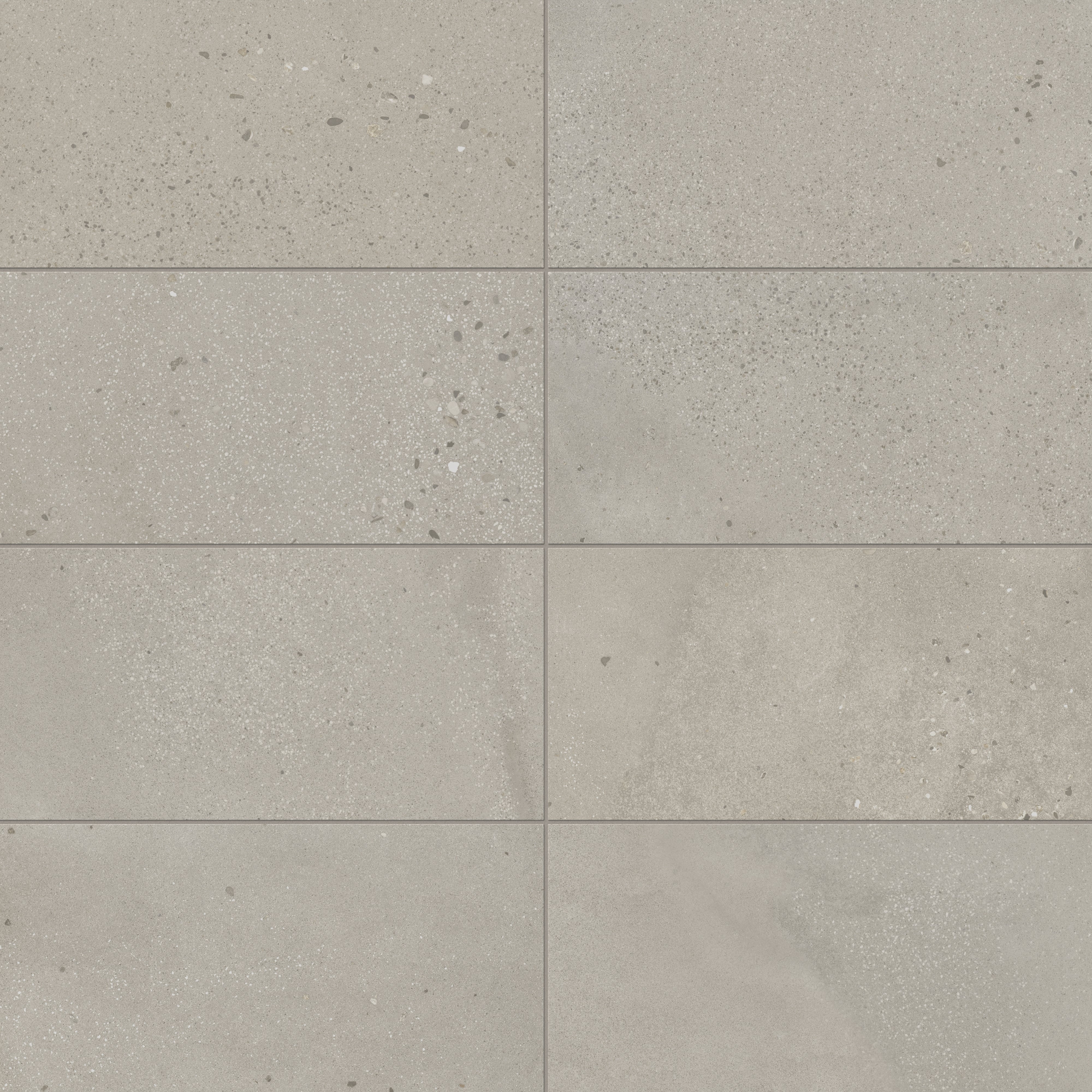 Sloane 12x24 matte porcelain tile in Sandstone, showcasing a soft beige tone with speckled accents, perfect for warm, neutral interior designs.