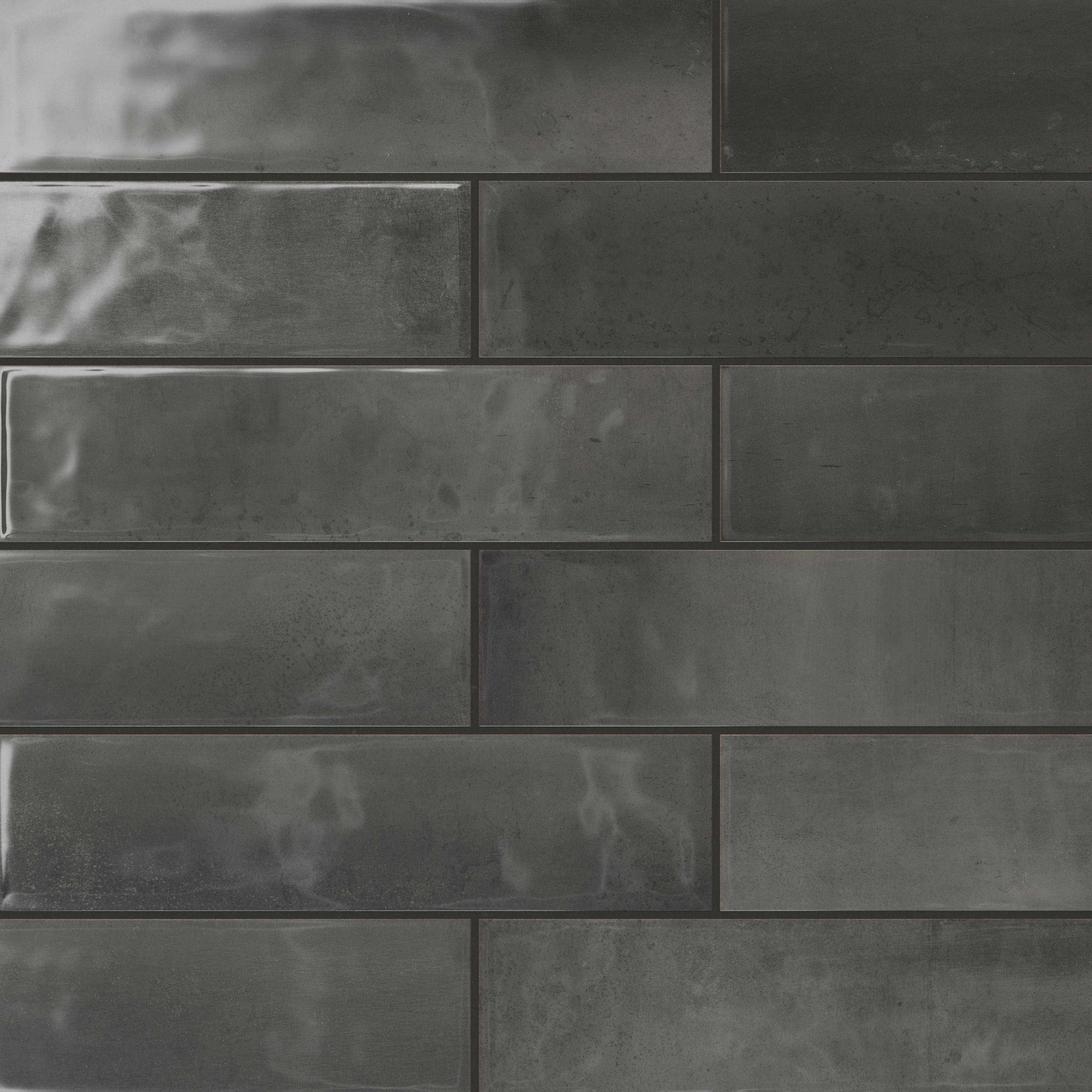 Dark grey 4x16 subway tiles with a glossy finish deliver a bold yet sophisticated vibe, ideal for creating a modern, stylish interior.
