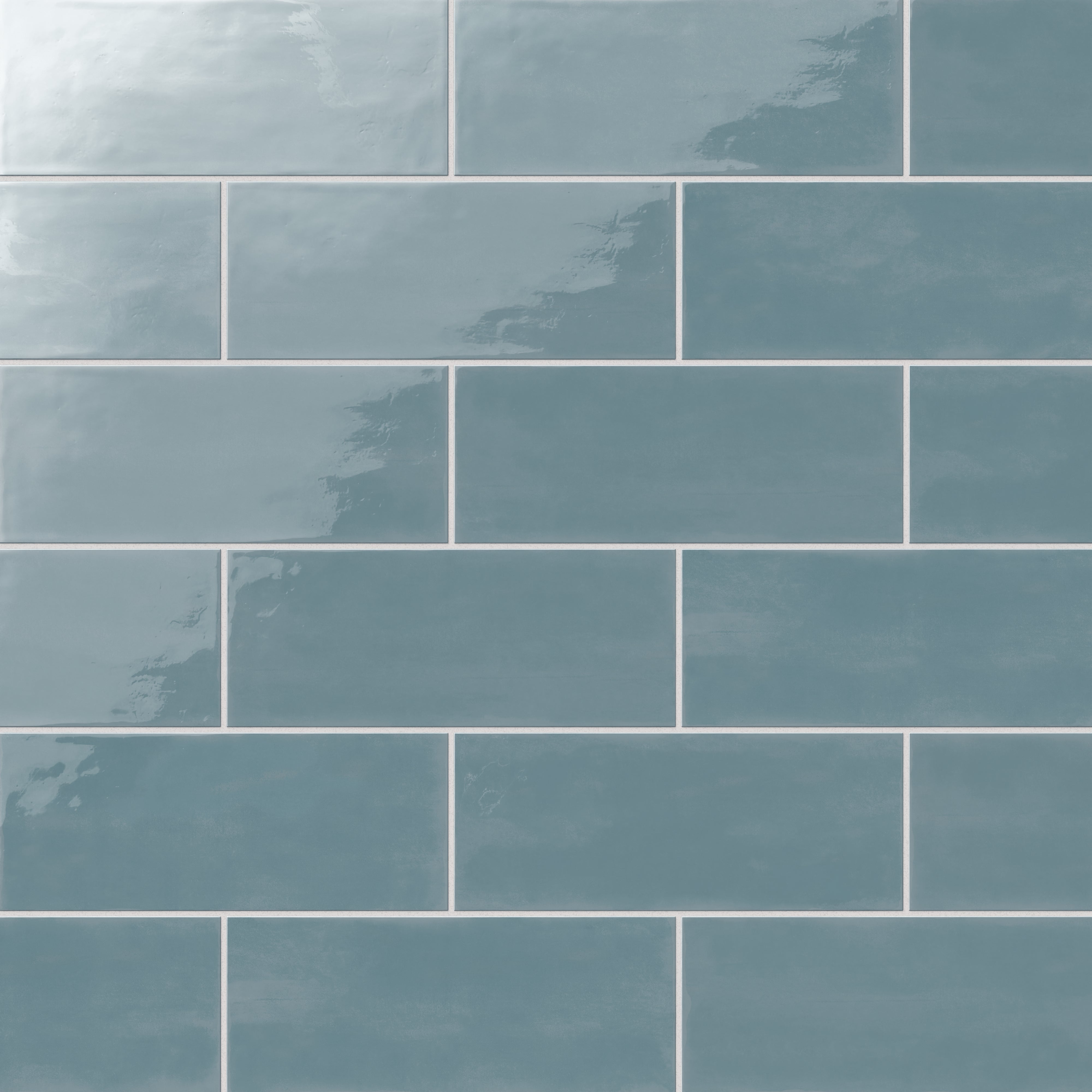 Vibrant ocean blue 4x10-inch glossy ceramic subway tiles arranged in a staggered brick pattern for a bold, modern look