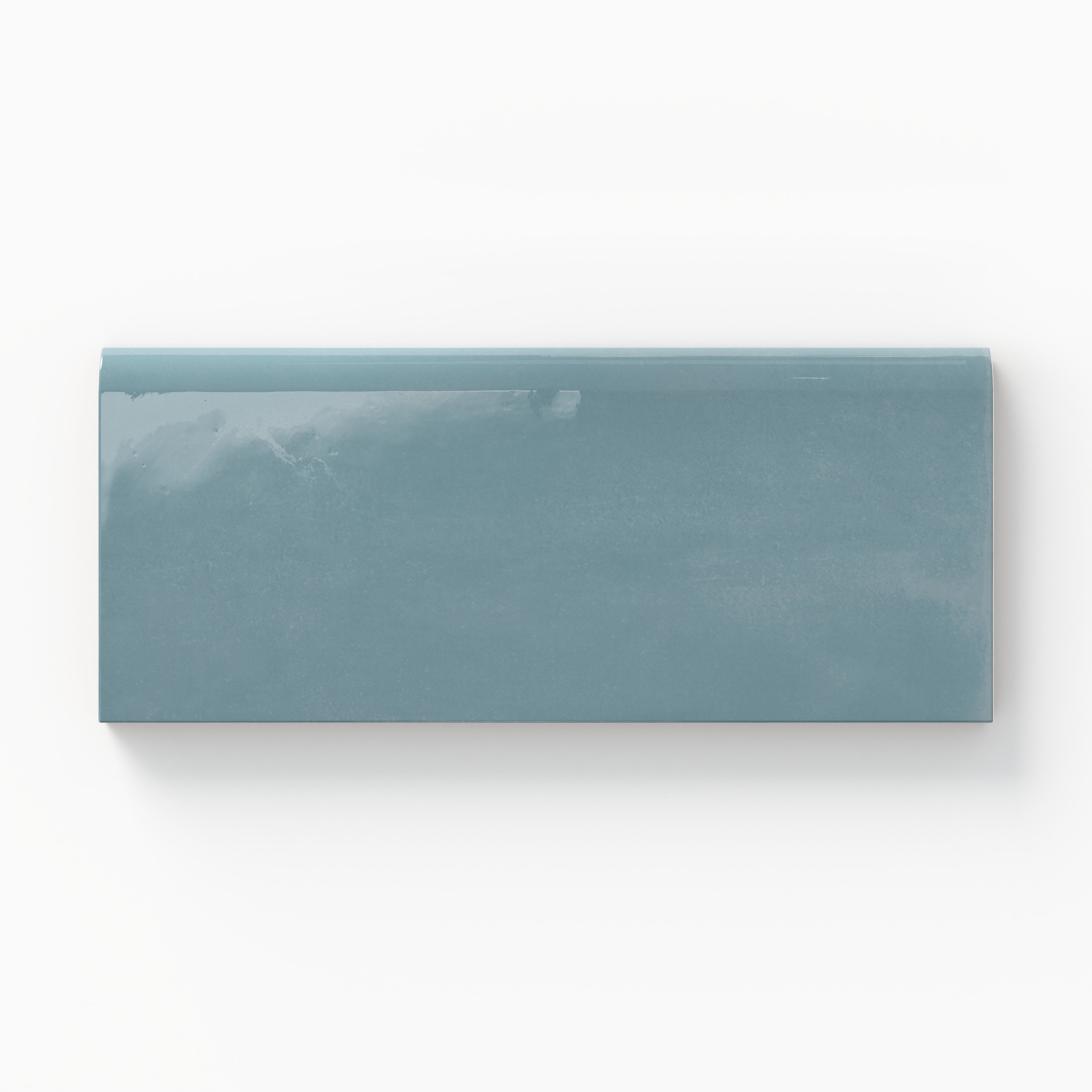 Glossy 3x6 bullnose tile with a rich blue-teal hue, ideal for adding vibrant coastal charm