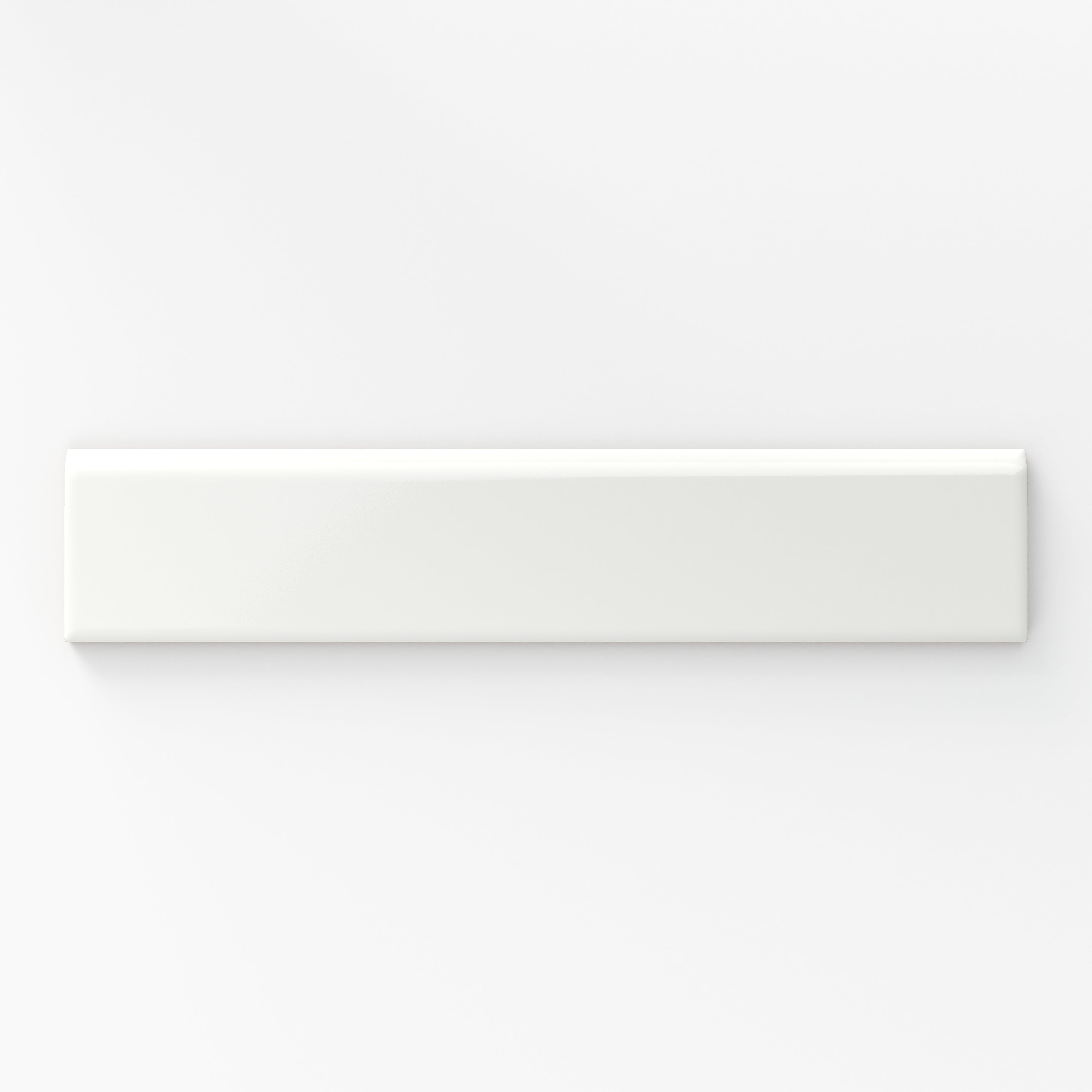 Glossy white bullnose tile with a smooth, reflective finish, perfect for creating clean, seamless edges in any design.