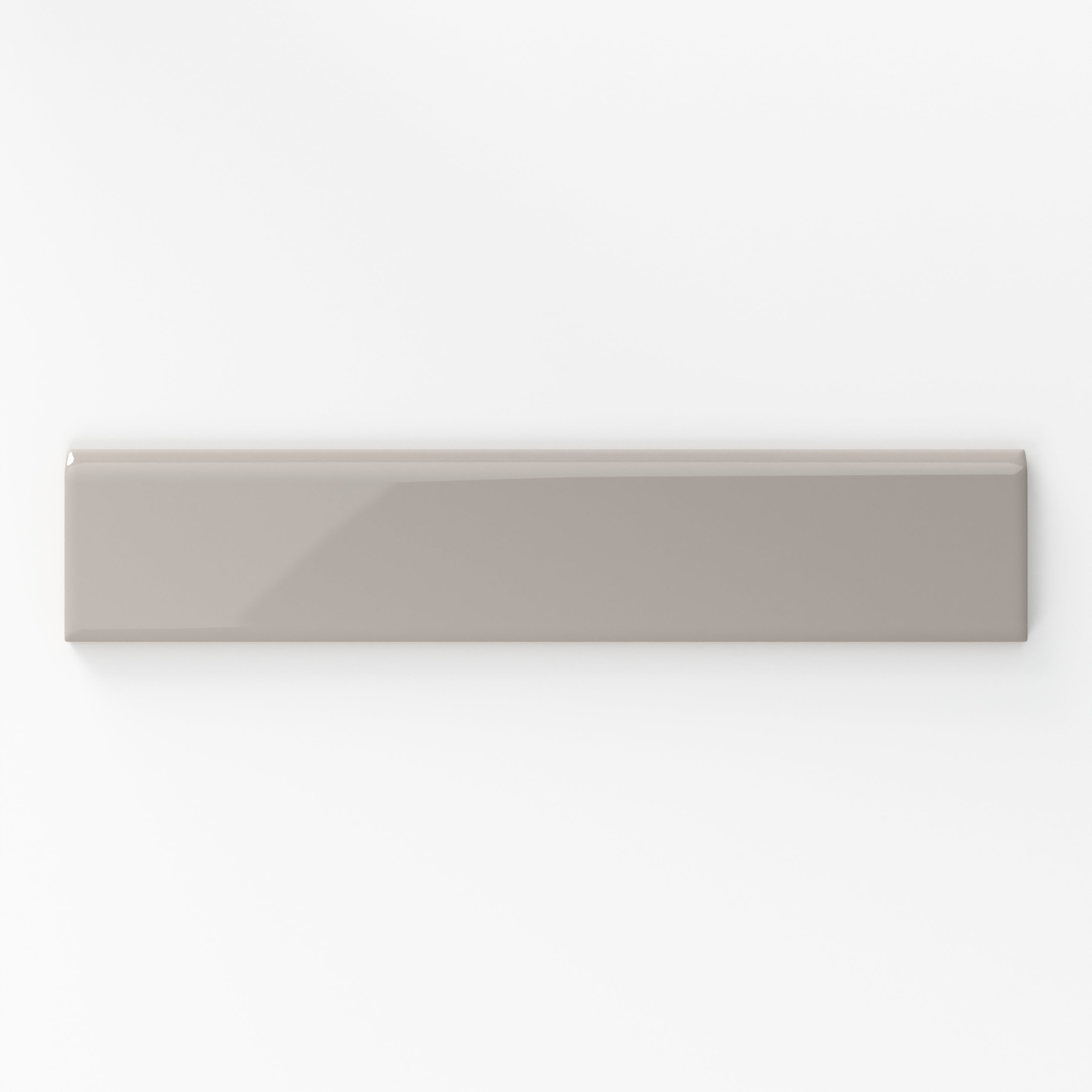 Sleek and glossy, the taupe 2x10bullnose tile is ideal for finishing edges with a polished look in contemporary settings.