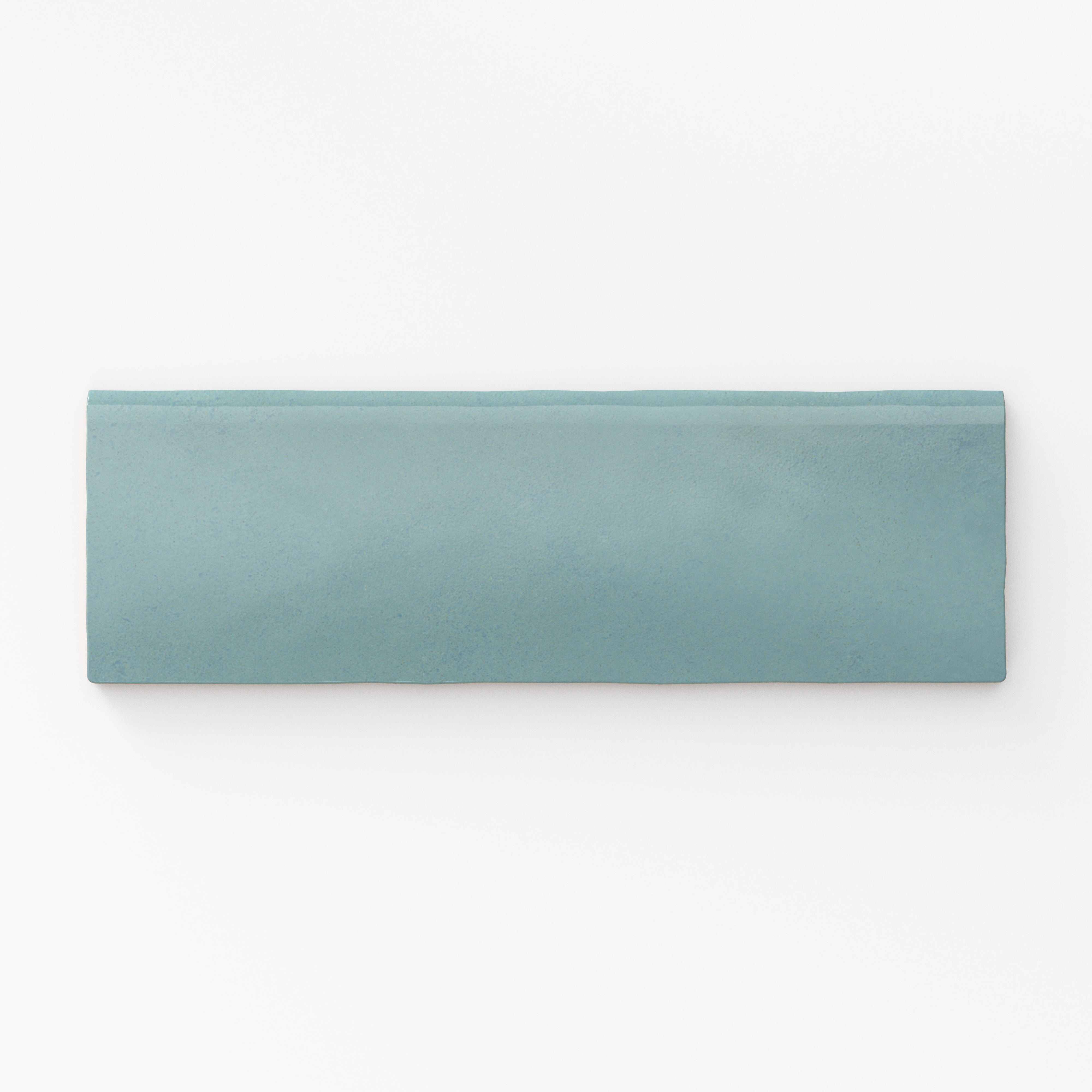 Soft teal bullnose tile with a matte finish, offering a smooth edge for seamless transitions
