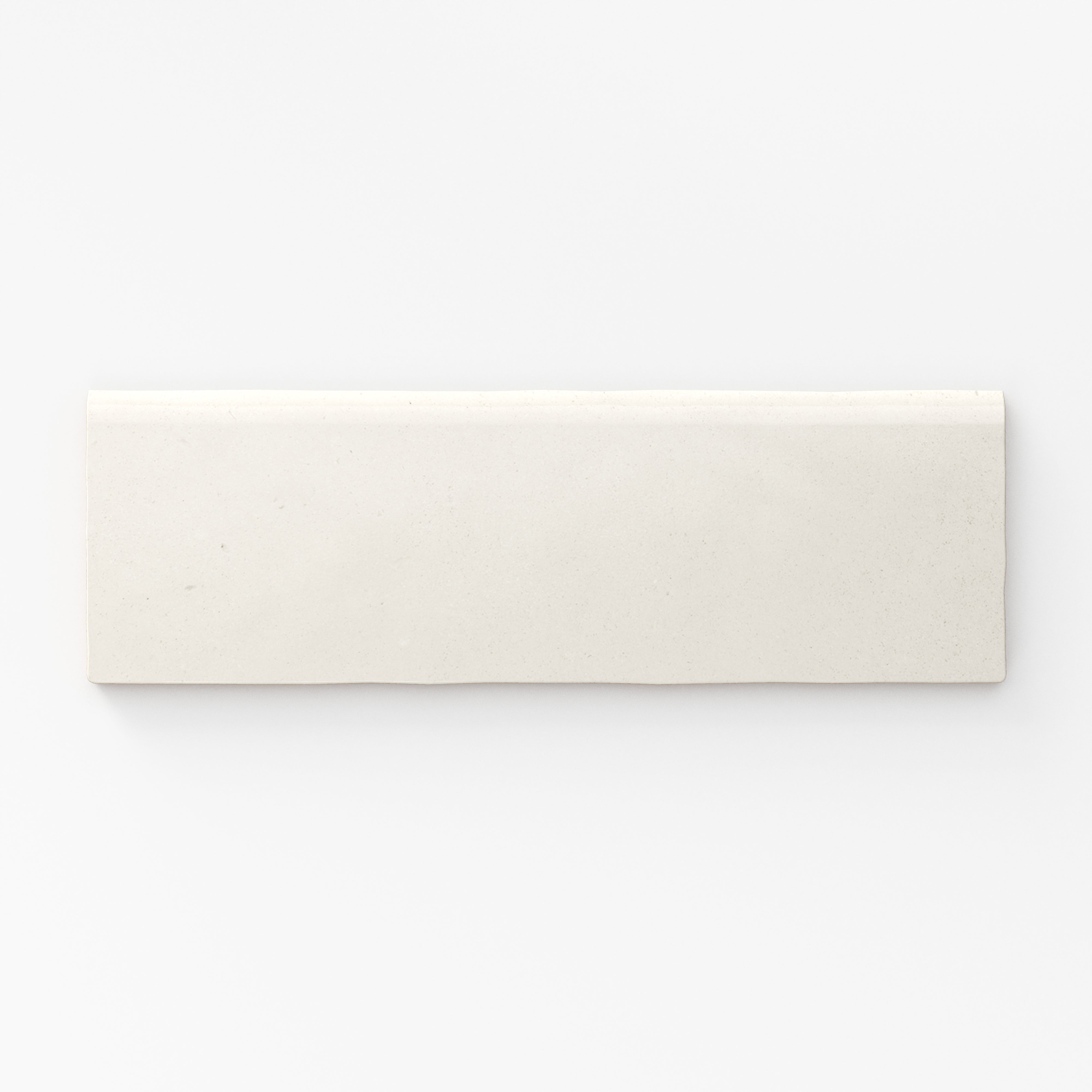 Soft eggshell-white matte tile with refined bullnose edges, perfect for minimalist elegance