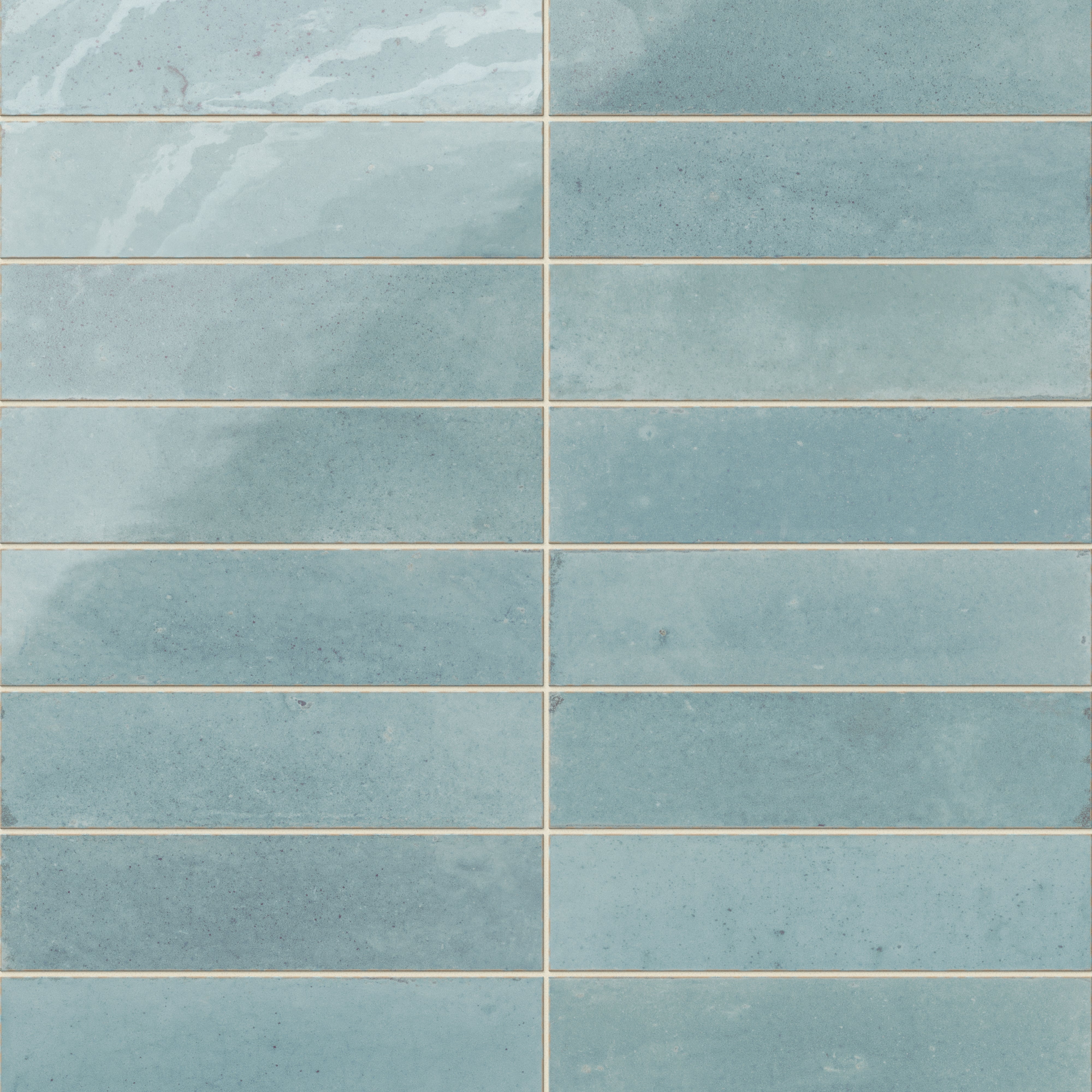 Subway porcelain tiles in soft blue with rustic surface variation and a handcrafted feel.