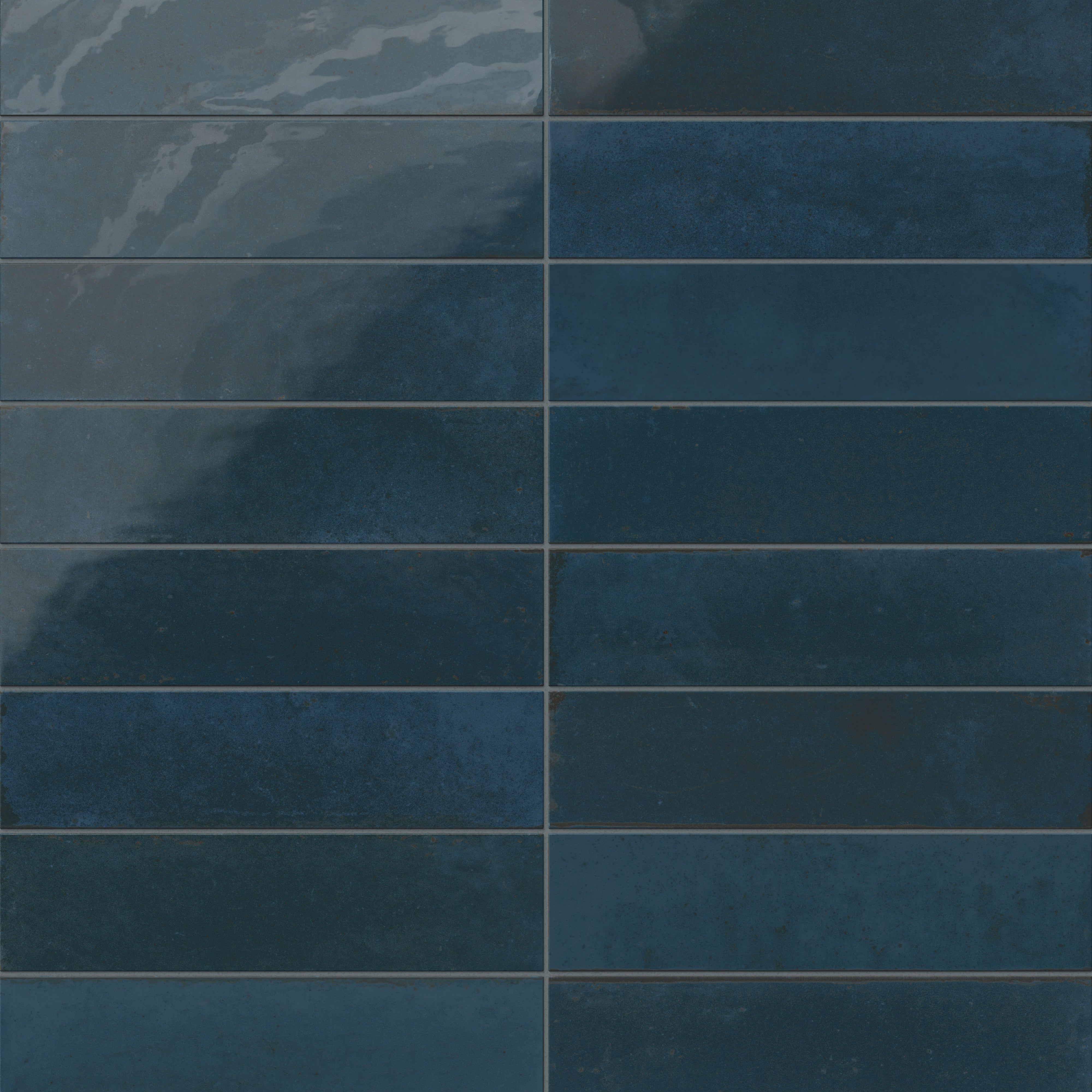 Subway porcelain tiles in deep navy blue with glossy variation and subtle rustic detailing.