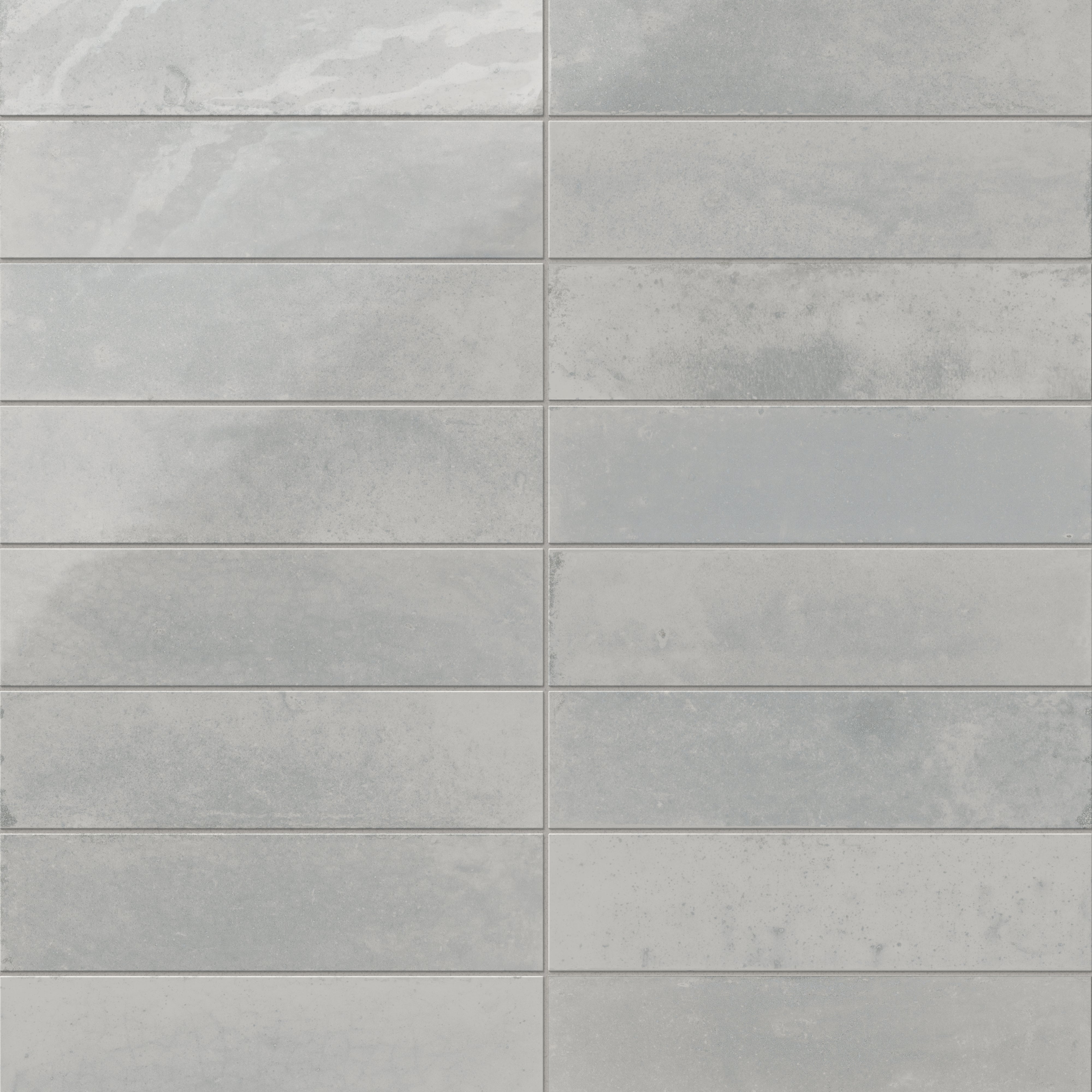 Glossy subway porcelain tiles in mixed gray tones, featuring a softly textured, rustic finish.