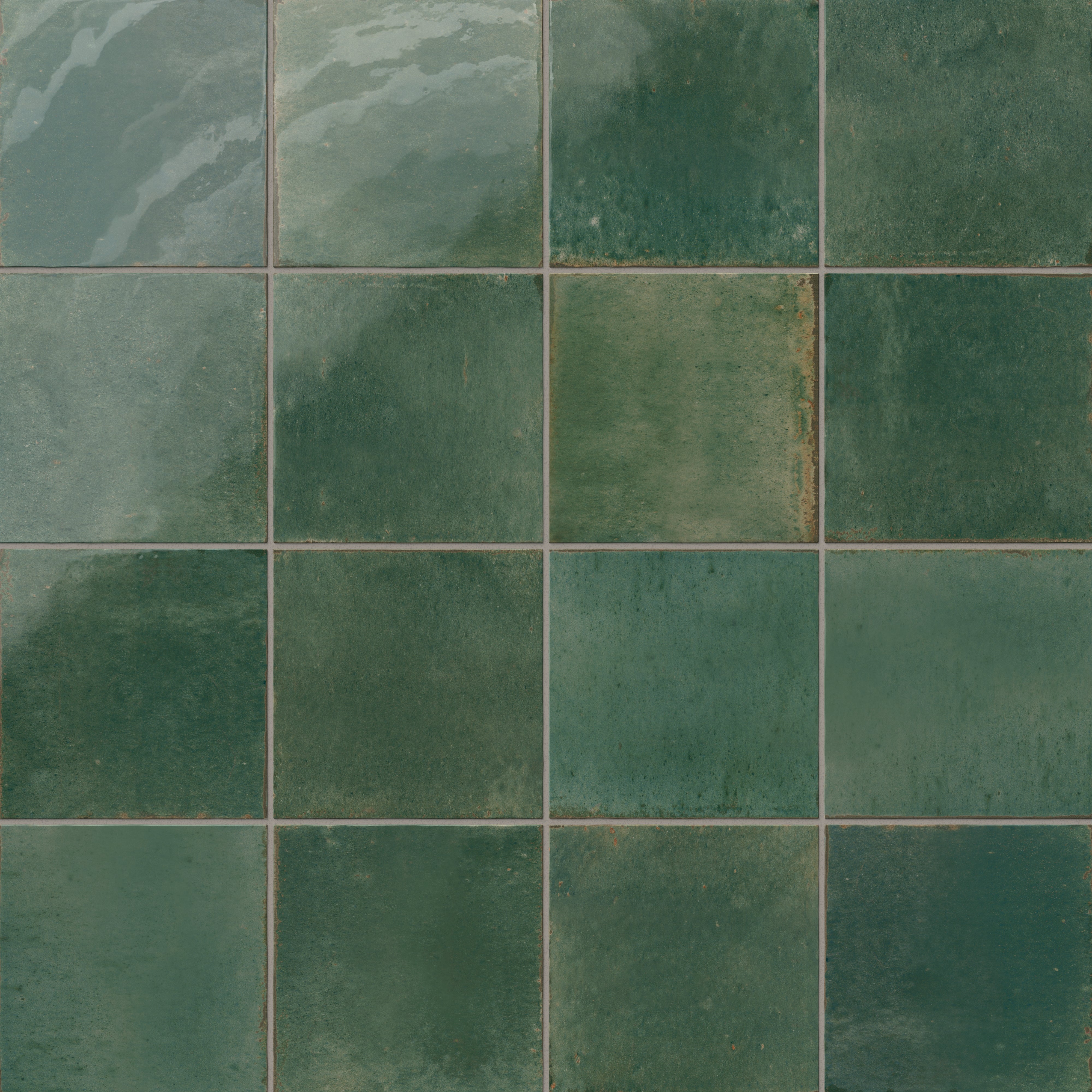 Glossy porcelain square tiles in dark green with a rustic, weathered finish and natural shade variation.