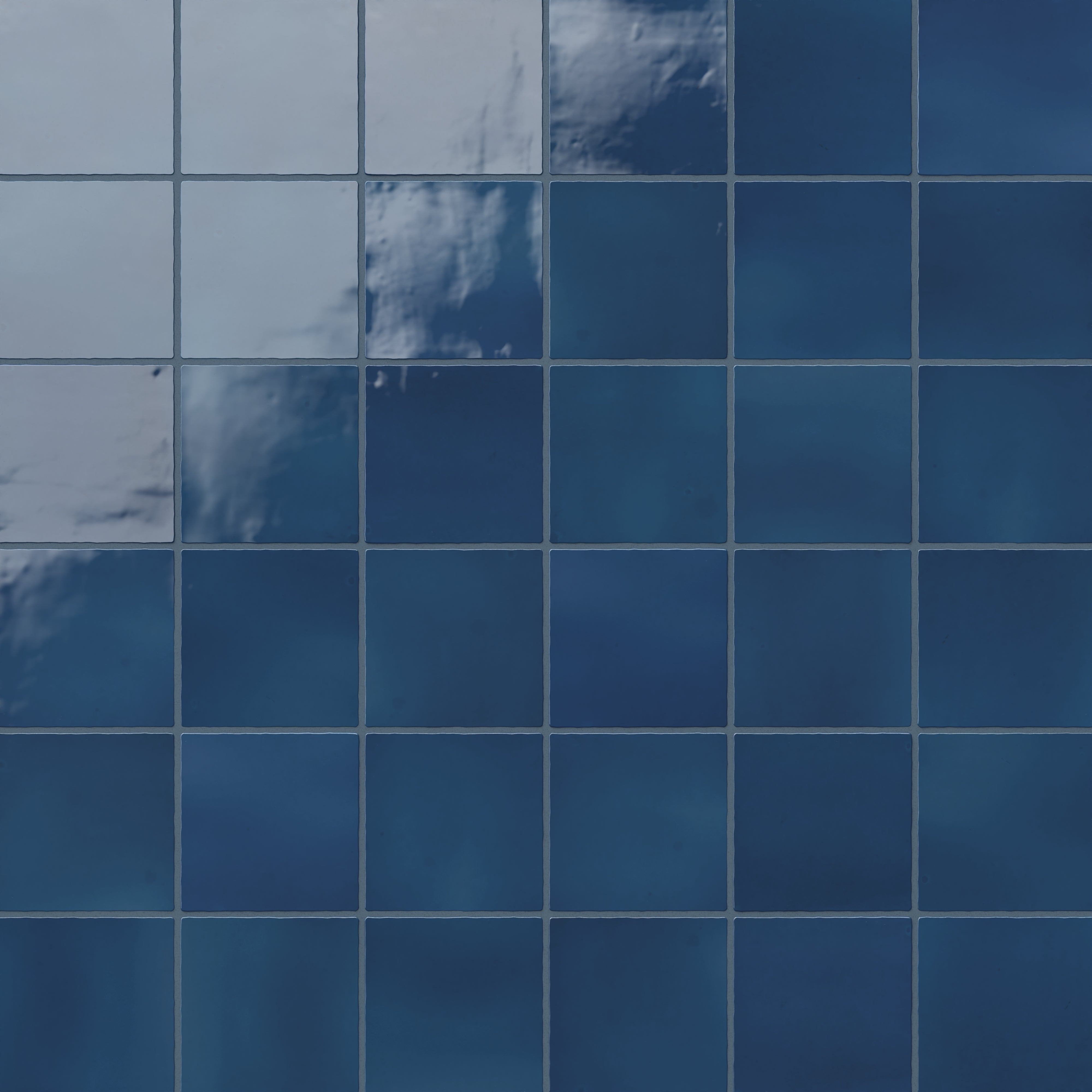 Deep cobalt blue 4x4 ceramic square tiles with a glossy finish, creating a vibrant and rich aesthetic for walls or surfaces