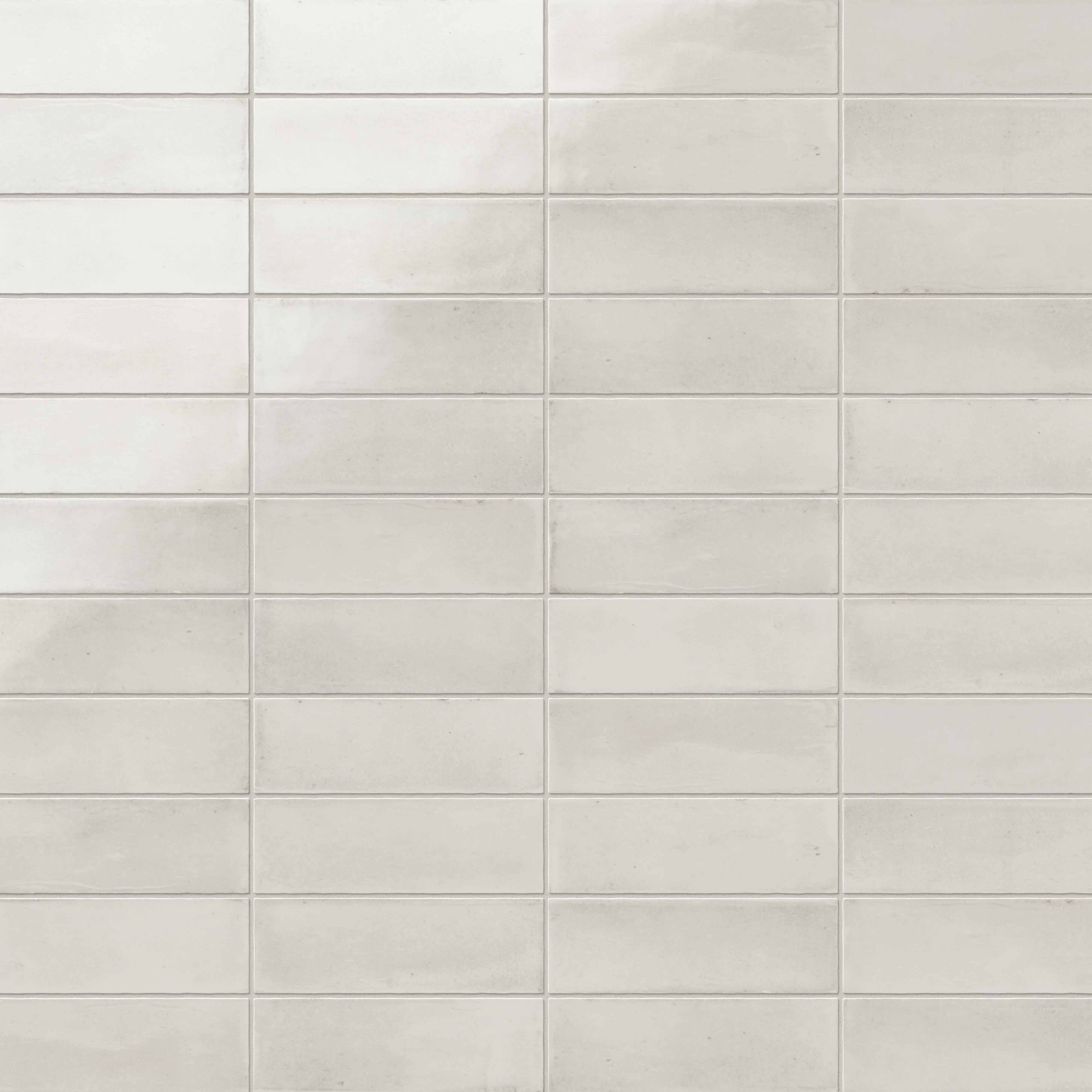A 2x6 porcelain subway tile in creamy white, featuring a glossy finish, and a clean stacked layout with fine grout lines.