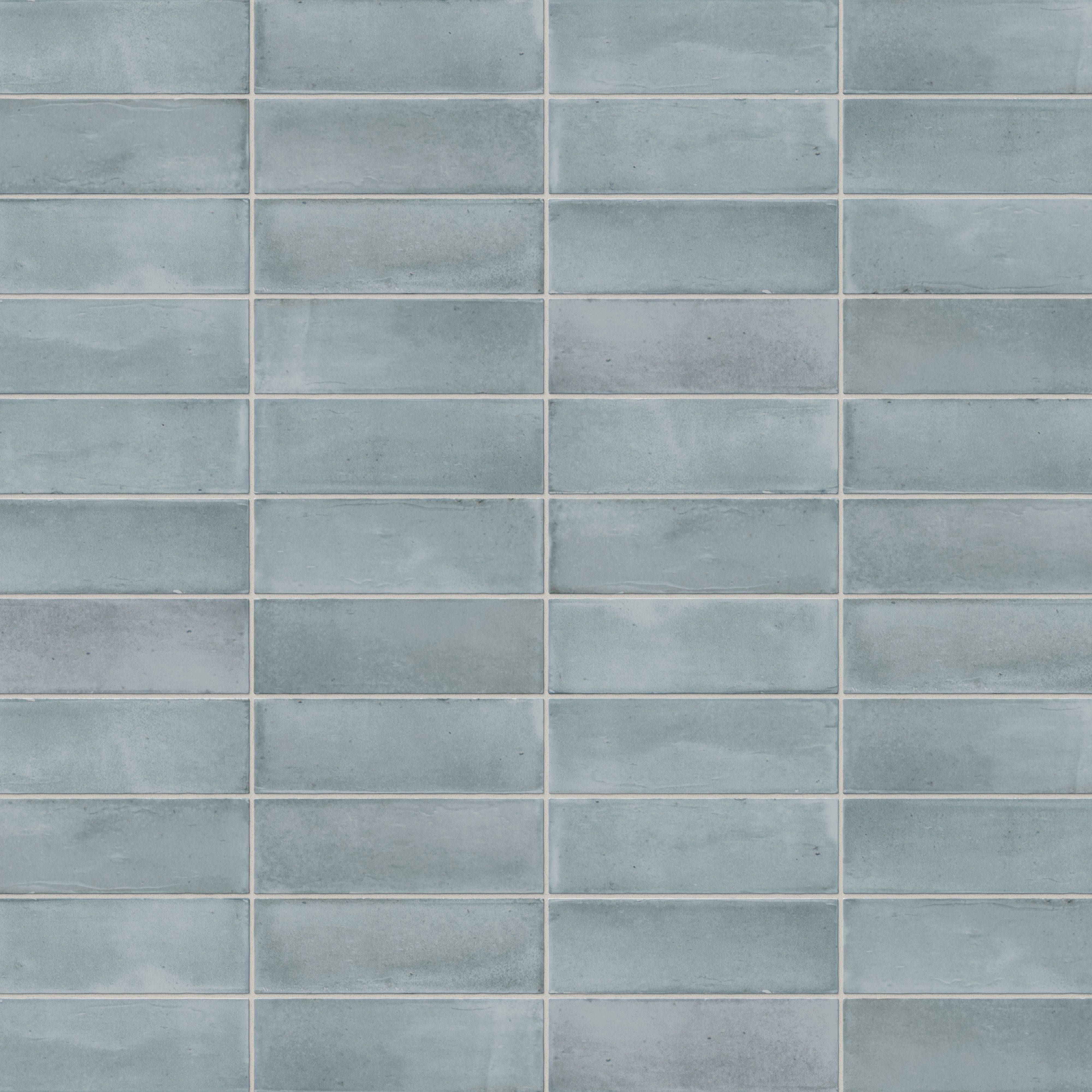 A 2x6 porcelain subway tiles in light blue, featuring a matte finish, and a clean stacked layout with fine grout lines.