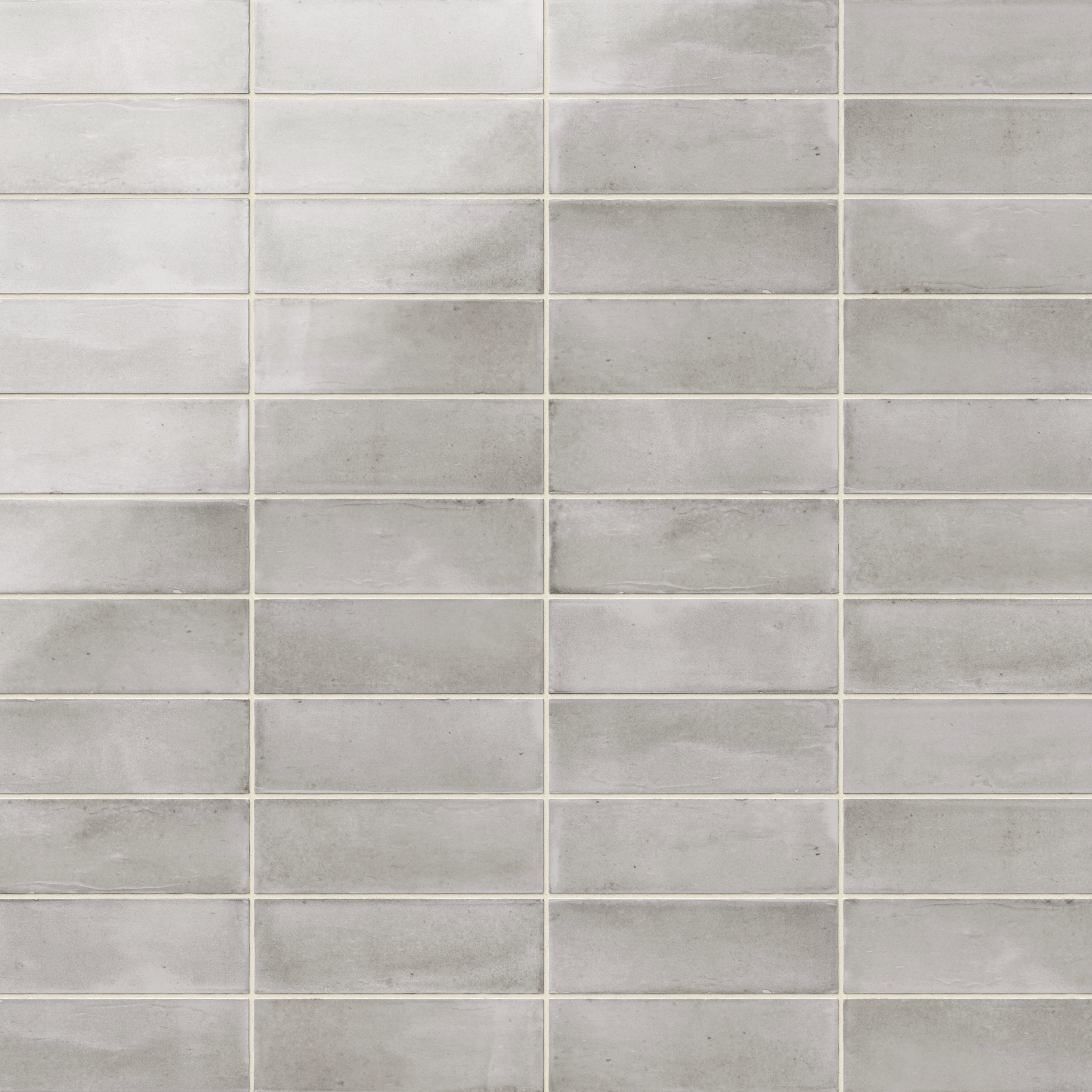 A 2x6 porcelain subway tiles in soft silver gray, featuring a glossy finish, and a clean stacked layout with fine grout lines.