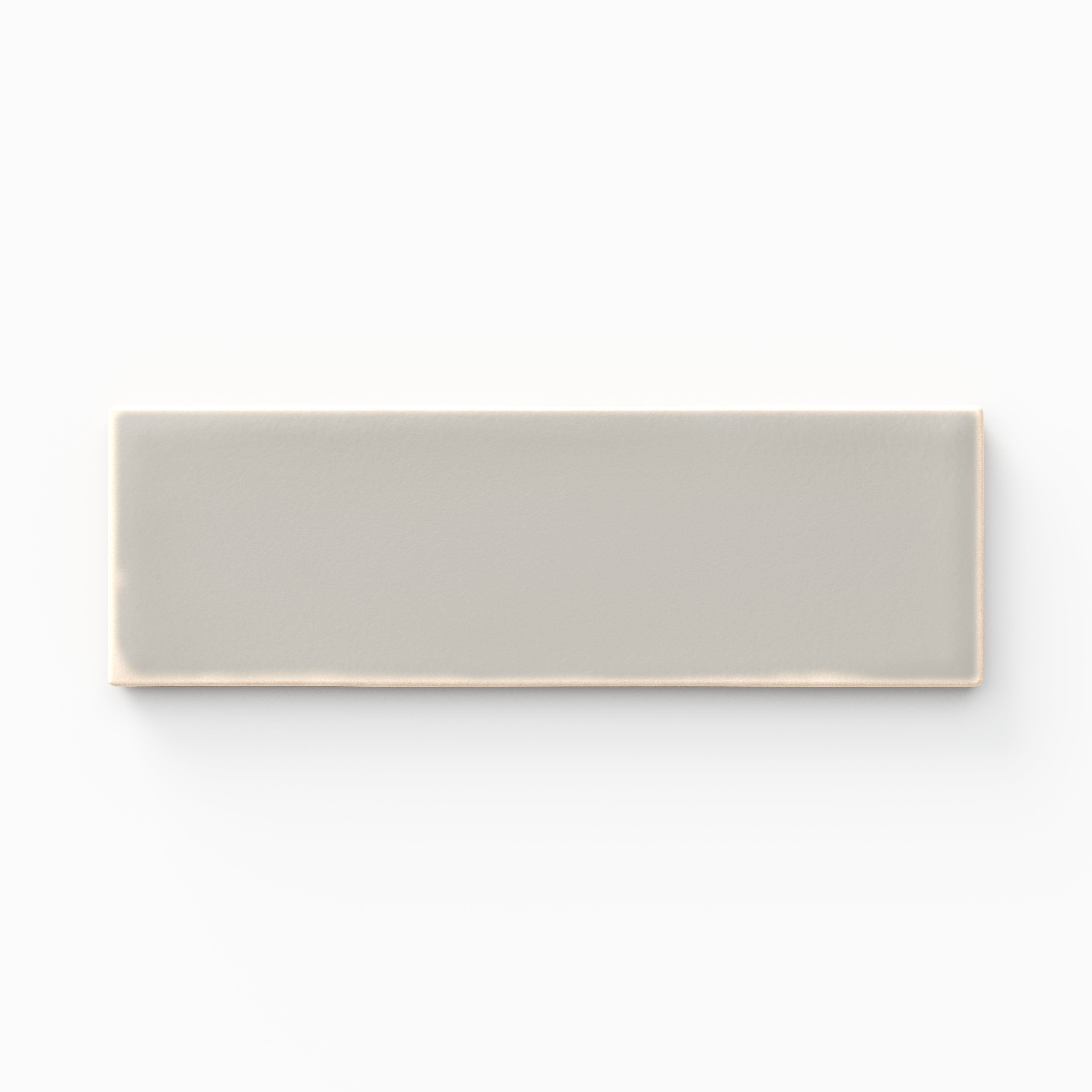 A 1.6x5 ceramic tile in light gray, featuring a matte finish, soft tonal variation, and a clean, flat-edge profile.