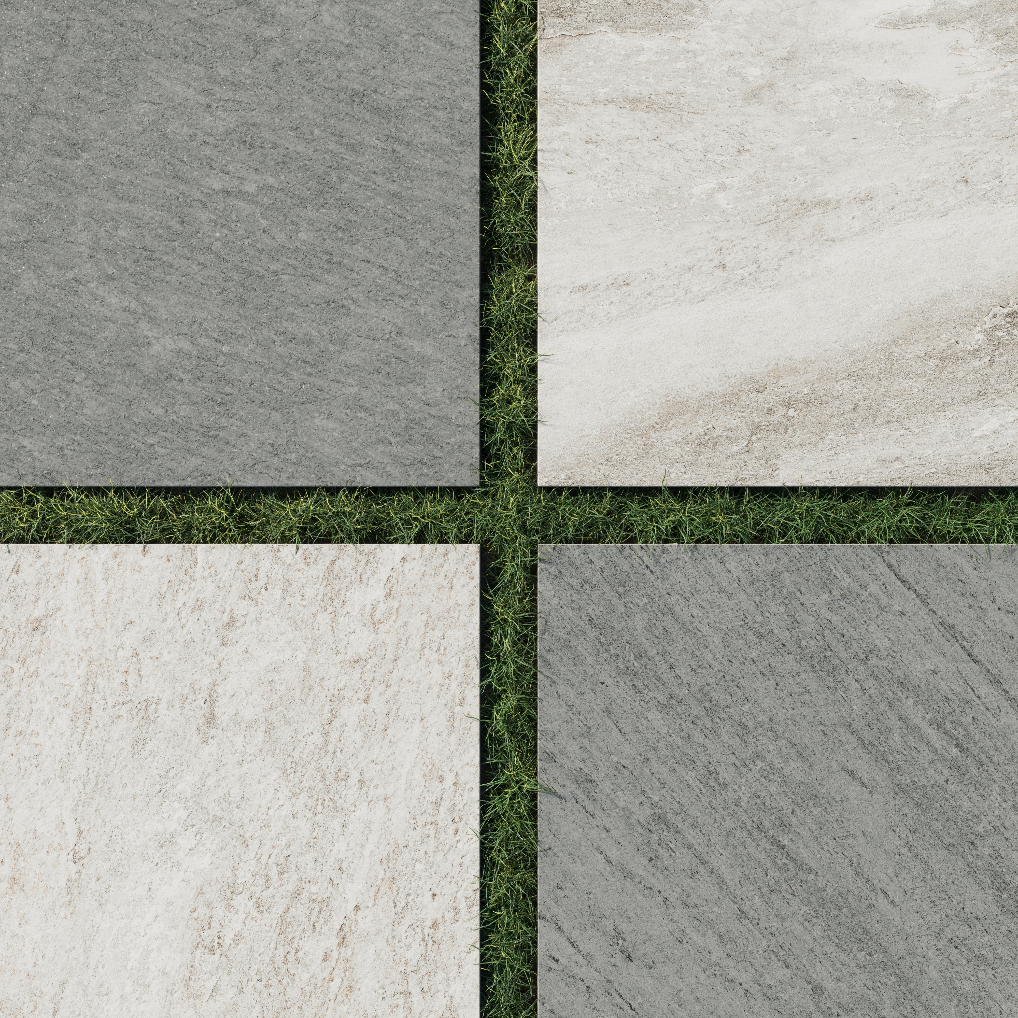 Stone-look outdoor porcelain tiles in neutral tones are arranged in a a checkerboard layout over grass, showcasing anti-slip, textured surfaces ideal for modern patios or garden paths