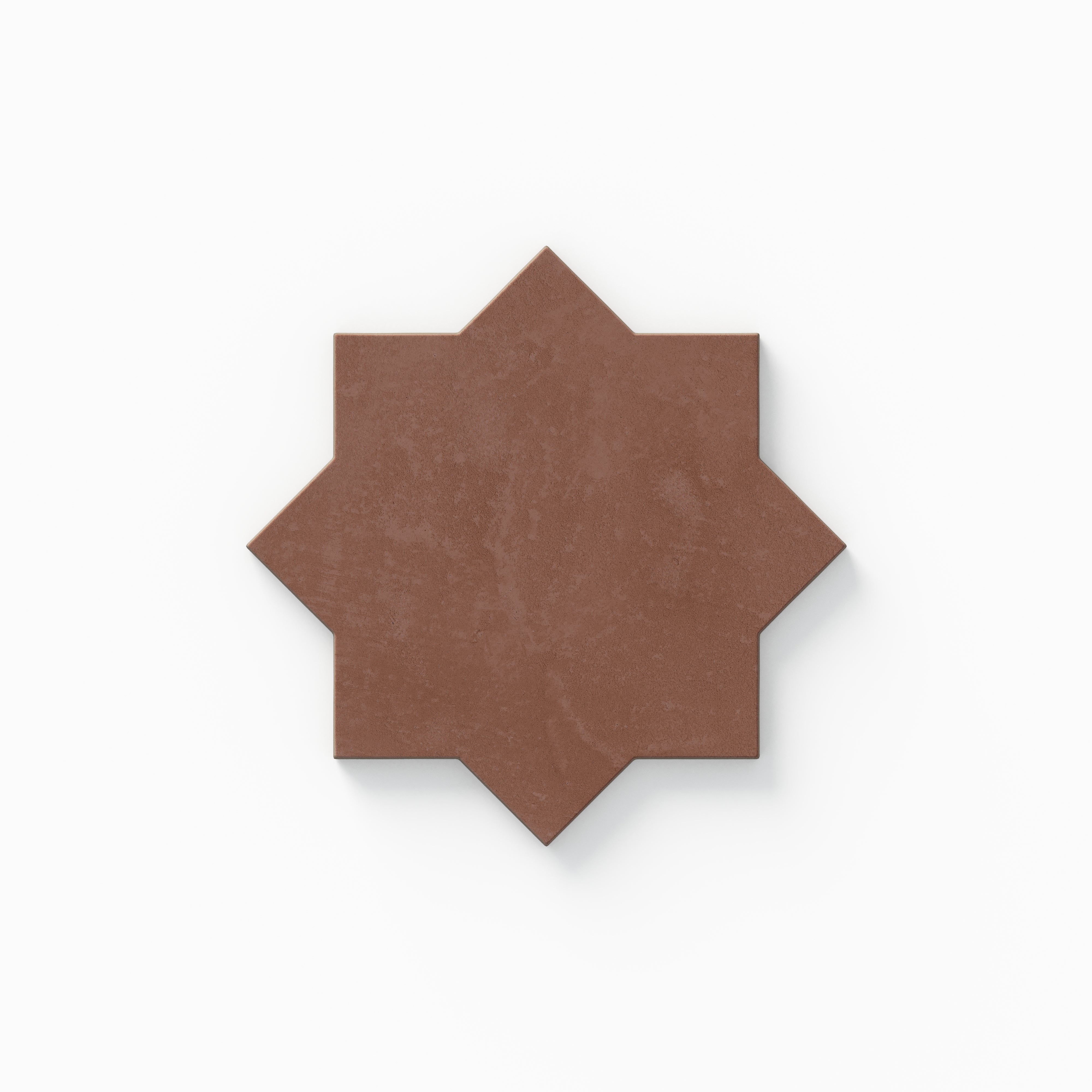 Part of our Isabel 11x11 Matte Porcelain Star and Cross set, this star tile shows red hues with soft cement texture and a powdery finish inspired by aged terracotta.