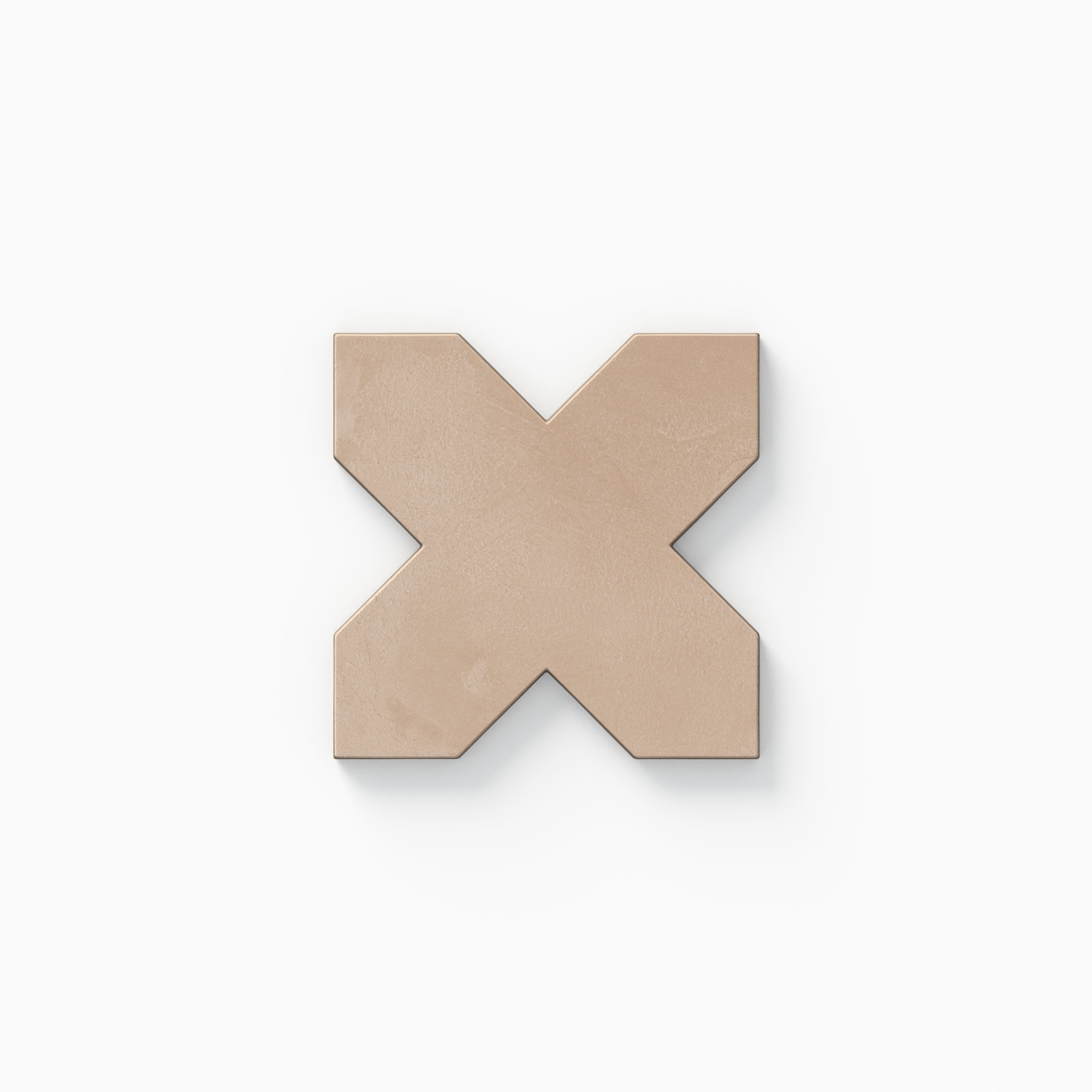 This decorative cross tile from our Isabel 11x11 Matte Porcelain collection shows beige coloring with gentle pink warmth, subtle cement textures, and a soft, powdery surface.