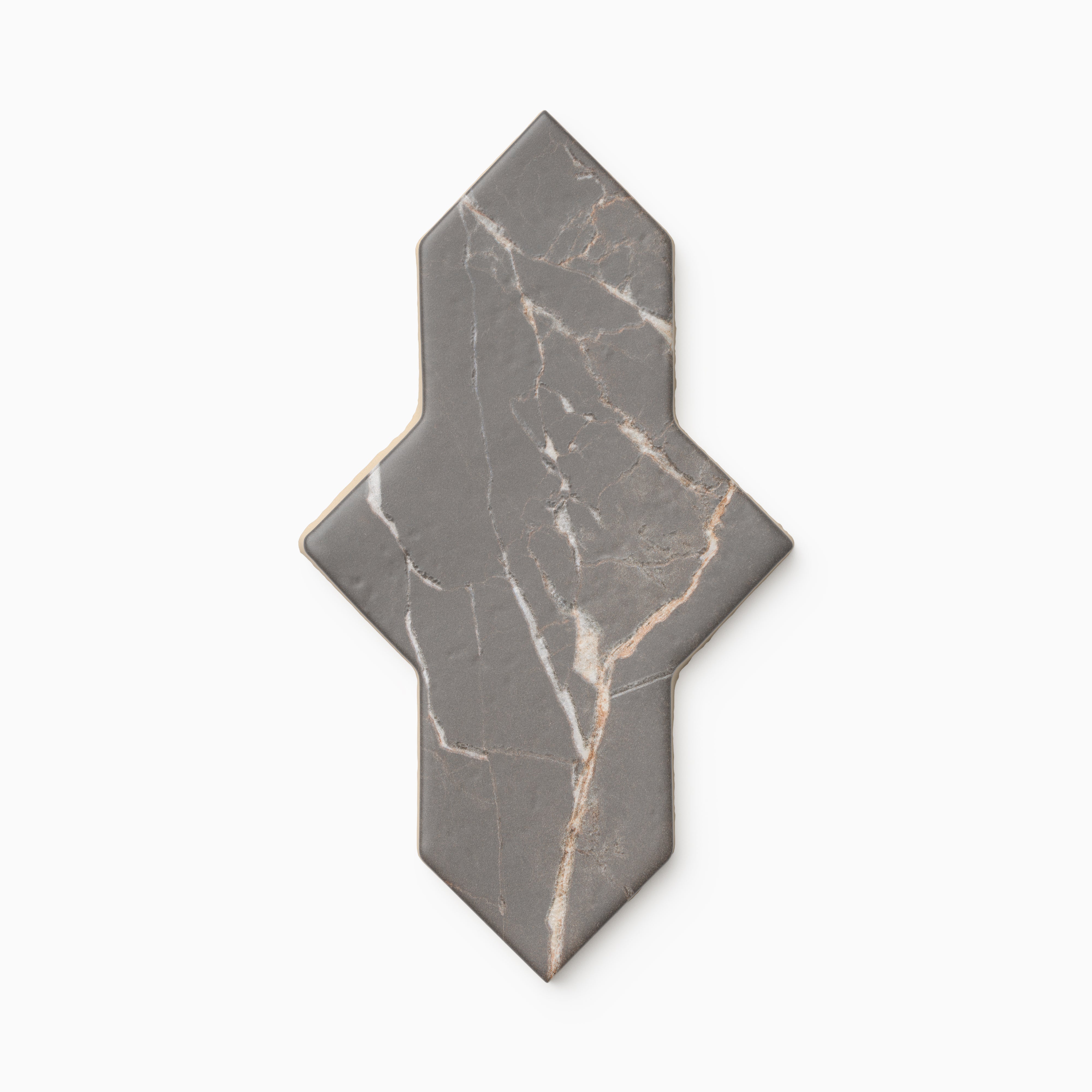 Dark gray Aslan 2x8 porcelain tile in a shield shape, showing subtle marble-like veining across a matte finish with gently rounded edges and a naturally aged appearance.