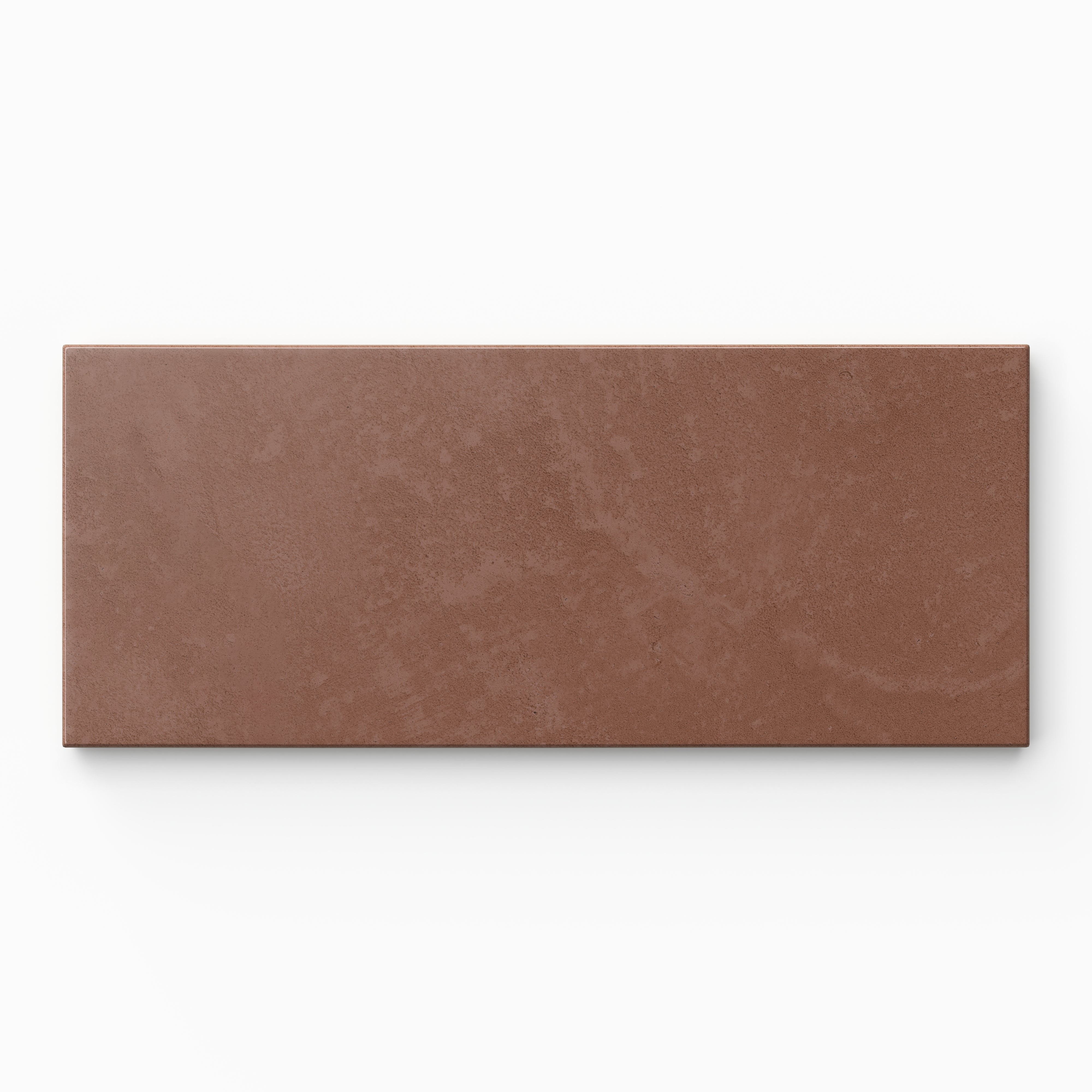Isabel 2.5x12 Matte Porcelain Tile in Rust highlights an elongated subway shape with muted red hues, a softly textured cement-plaster surface, and a calm matte look.