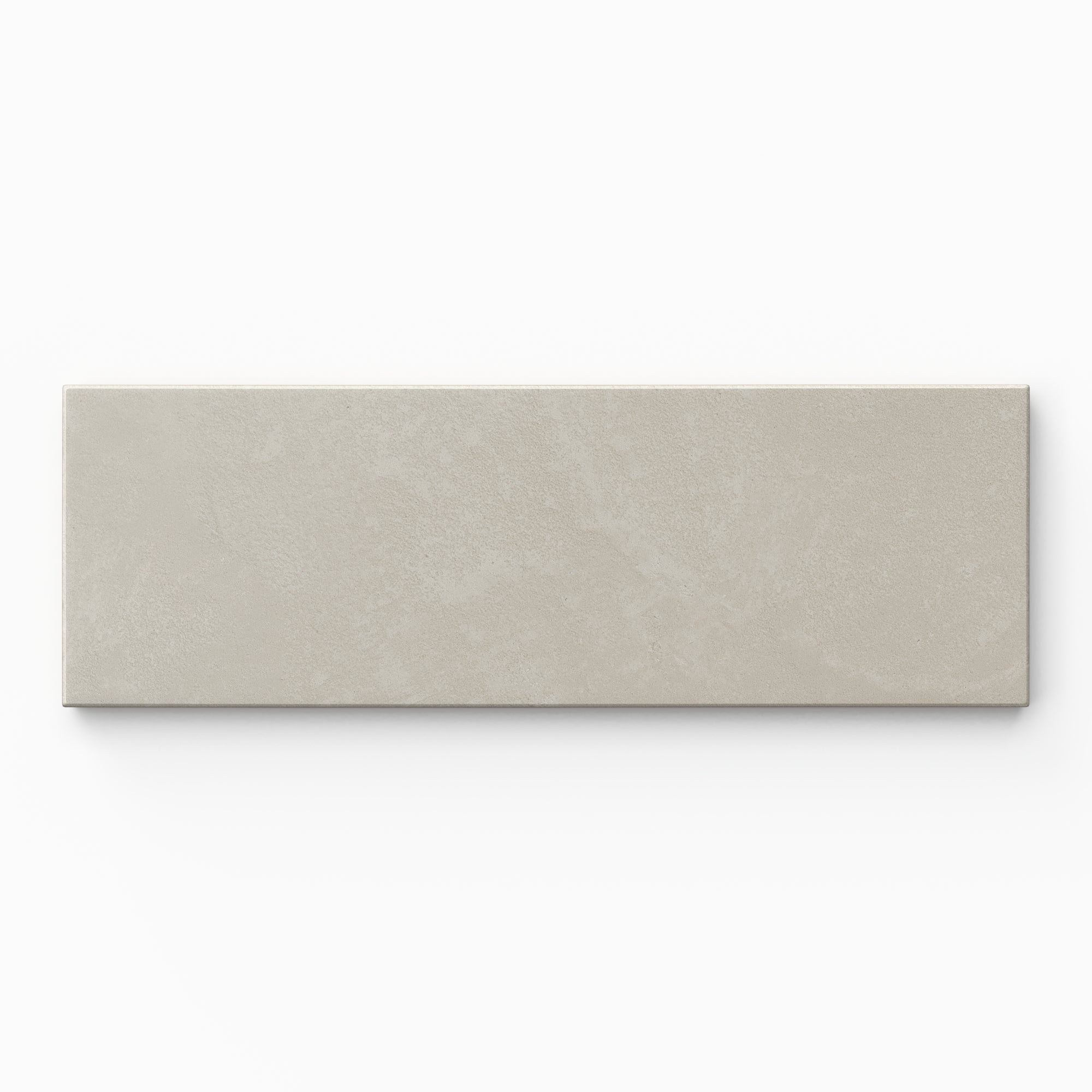 Isabel 2x6 Matte Porcelain Tile in Dove shows calm light gray shading with quiet variation, a soft powdery glaze, and lightly textured cement-plaster character.